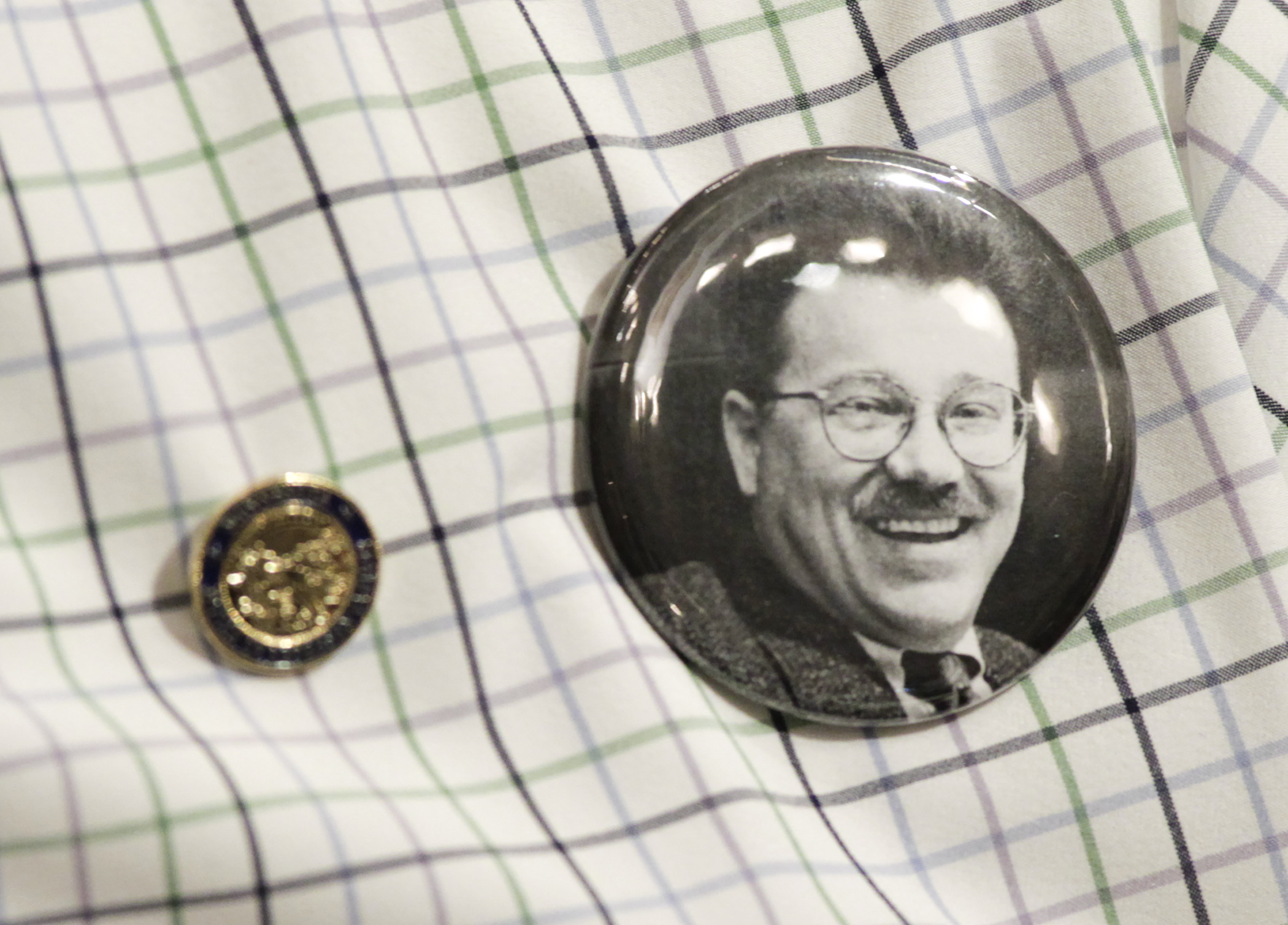 Rep. Brad Tabke wears a Tom Rukavina button as members spoke on the House Floor Jan. 10 about the former member from Virginia who died earlier this week. Photo by Paul Battaglia