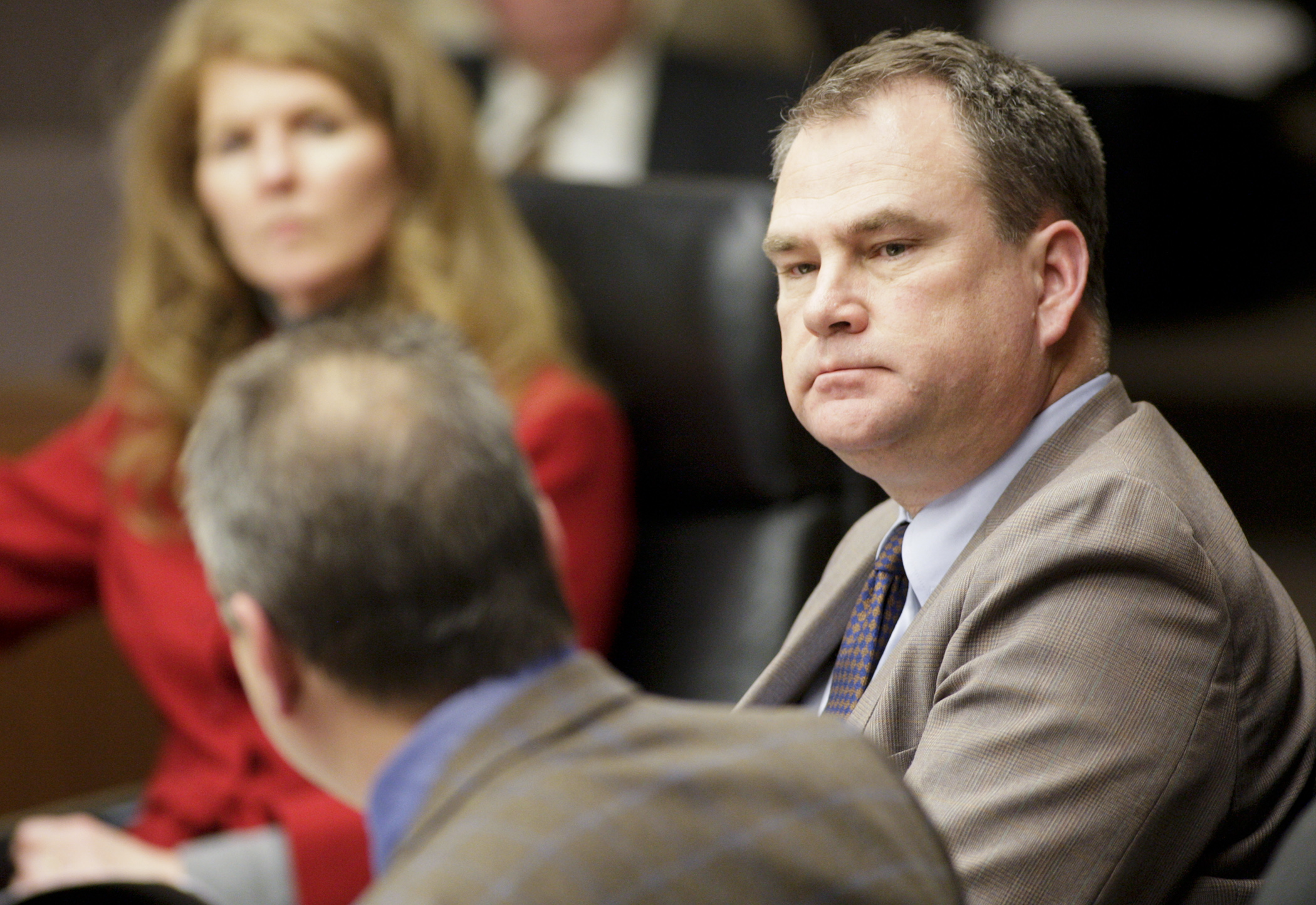Rep. Joe Hoppe, right, listens as Jim Schowalter, president and CEO of the Minnesota Council of Health Plans, testifies Jan. 11 before House Commerce and Regulatory Reform Committee in support of HF5, which would provide for a state-operated reinsurance program. Photo by Paul Battaglia