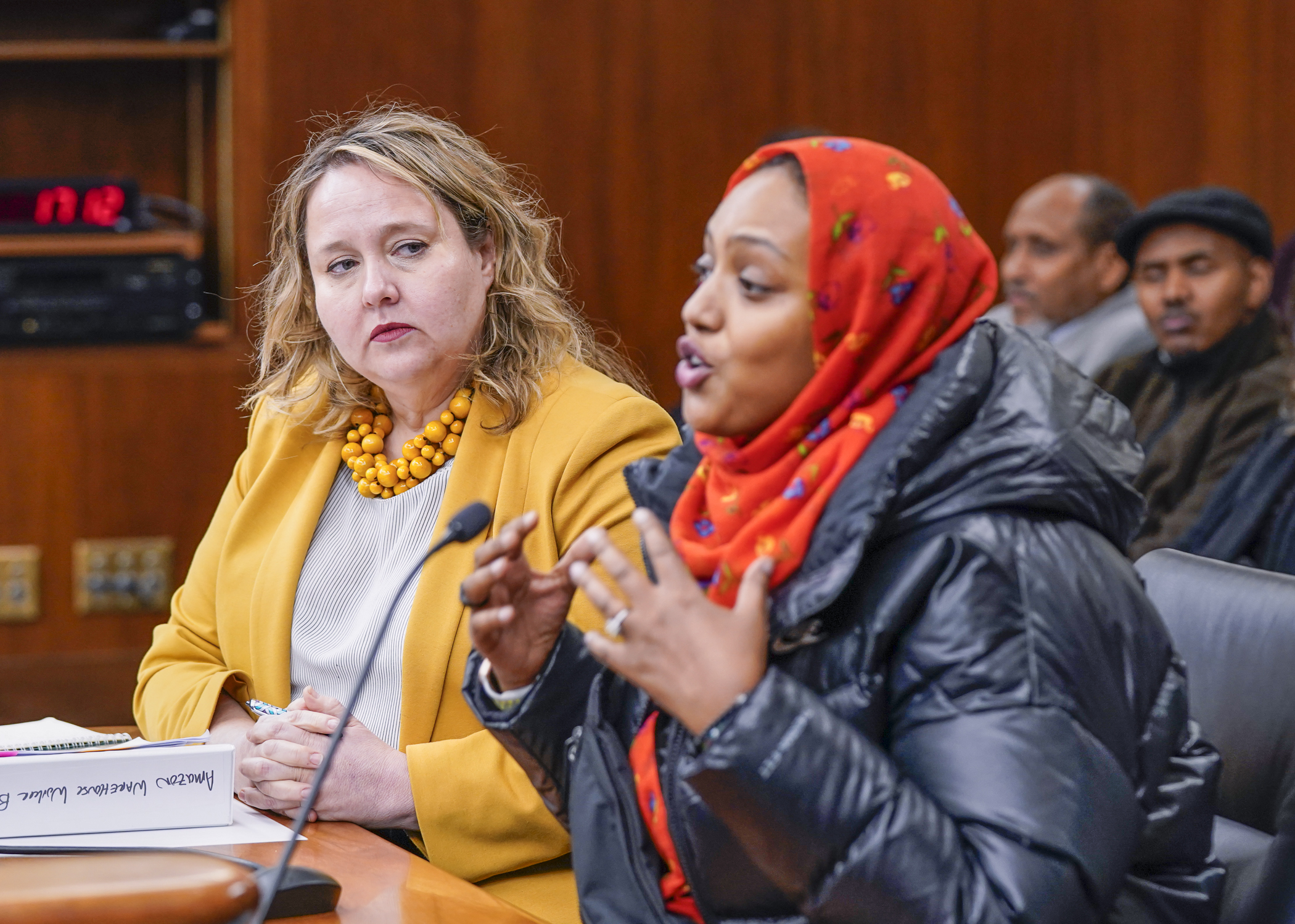 Khali Jama describes her experiences as an Amazon warehouse floor worker Thursday to the House labor committee. Rep. Emma Greenman, left, sponsors a bill to increase worker safety requirements in Minnesota warehouses. (Photo by Catherine Davis)