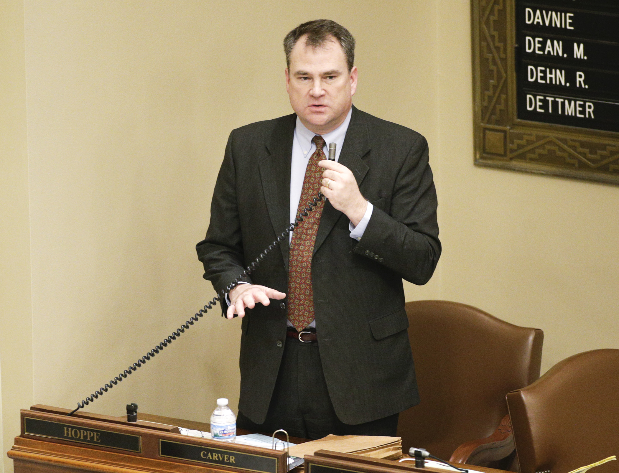 Rep. Joe Hoppe, chair of the House Commerce and Regulatory Reform Committee, introduces SF1, which would provide a temporary program to help pay for health insurance premiums, during debate on the House Floor Jan. 19. Photo by Paul Battaglia