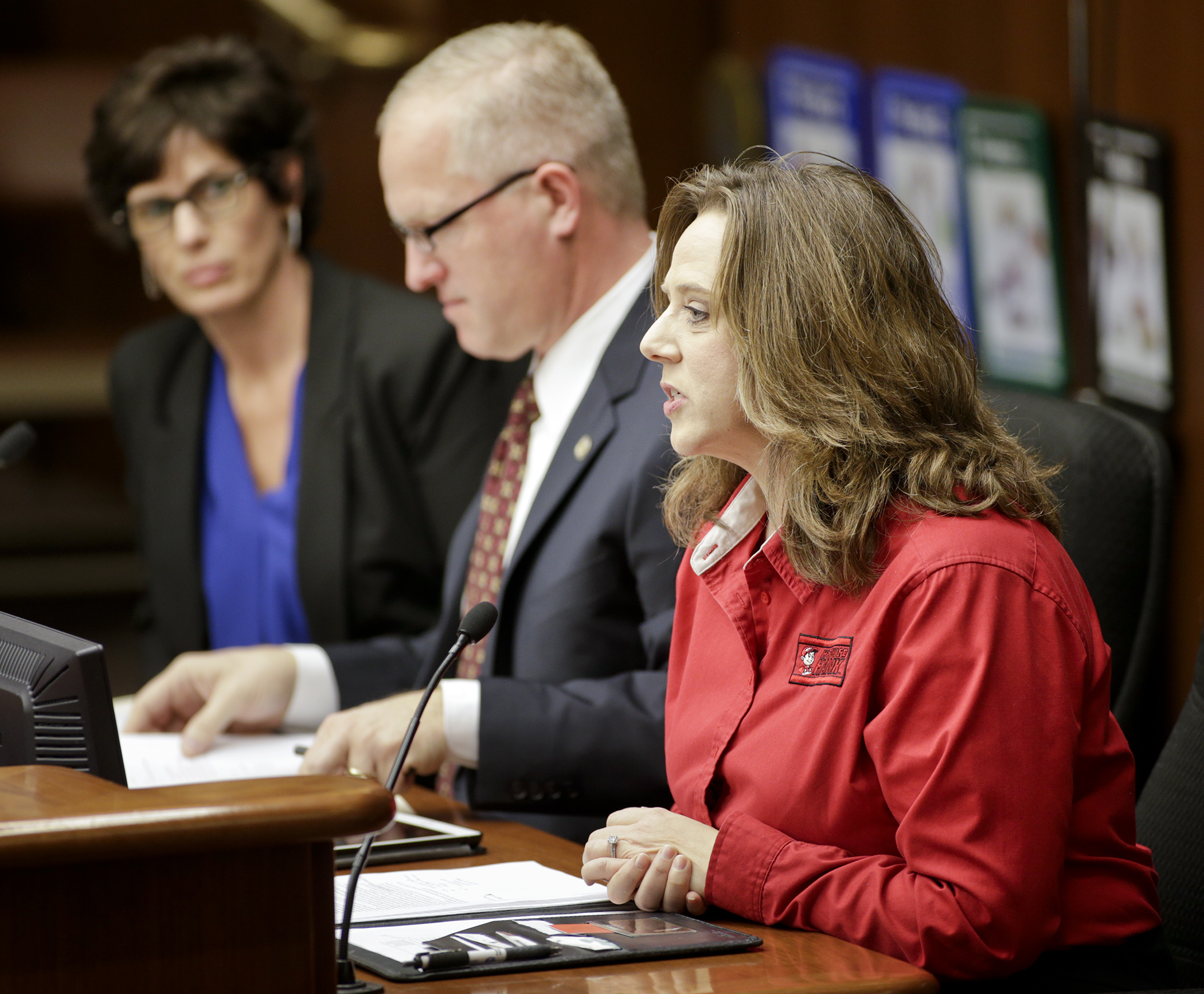 Deborah Everson, co-owner of Everson’s Hardware Hank in Waconia, testifies before the House Taxes Committee Jan. 19 in favor of HF186, sponsored by Rep. Jim Nash, center, which would provide an allowance for those collecting and remitting sales tax. At left is Rep. Barb Haley. Photo by Paul Battaglia