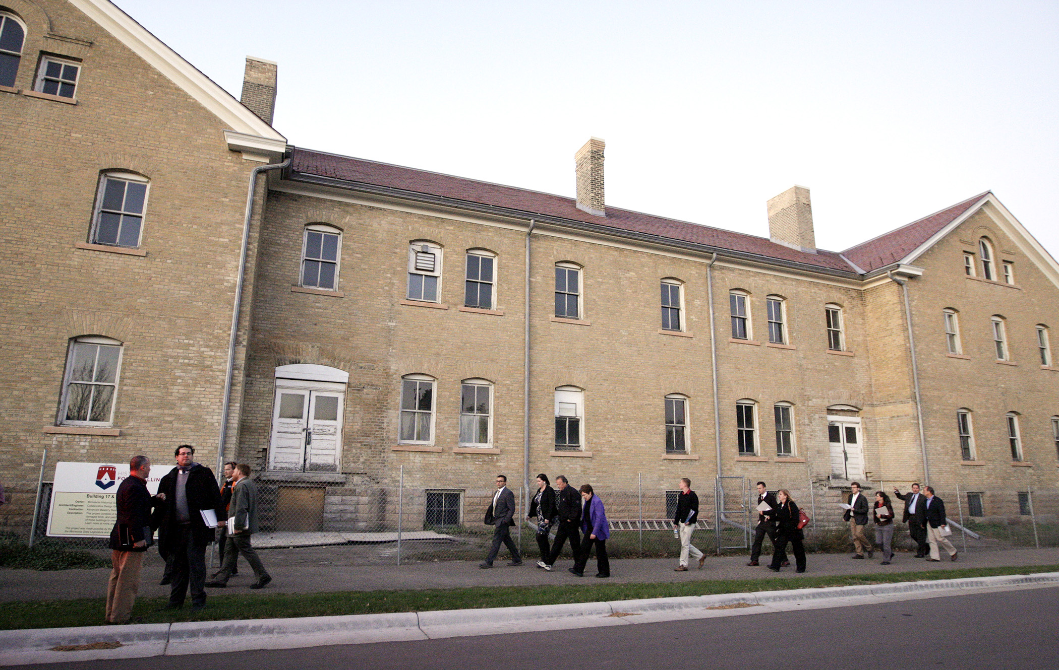 Members and staff of the House Capital Investment Committee walk by the historic cavalry barracks at Fort Snelling during a site visit in 2015. House Photography file photo