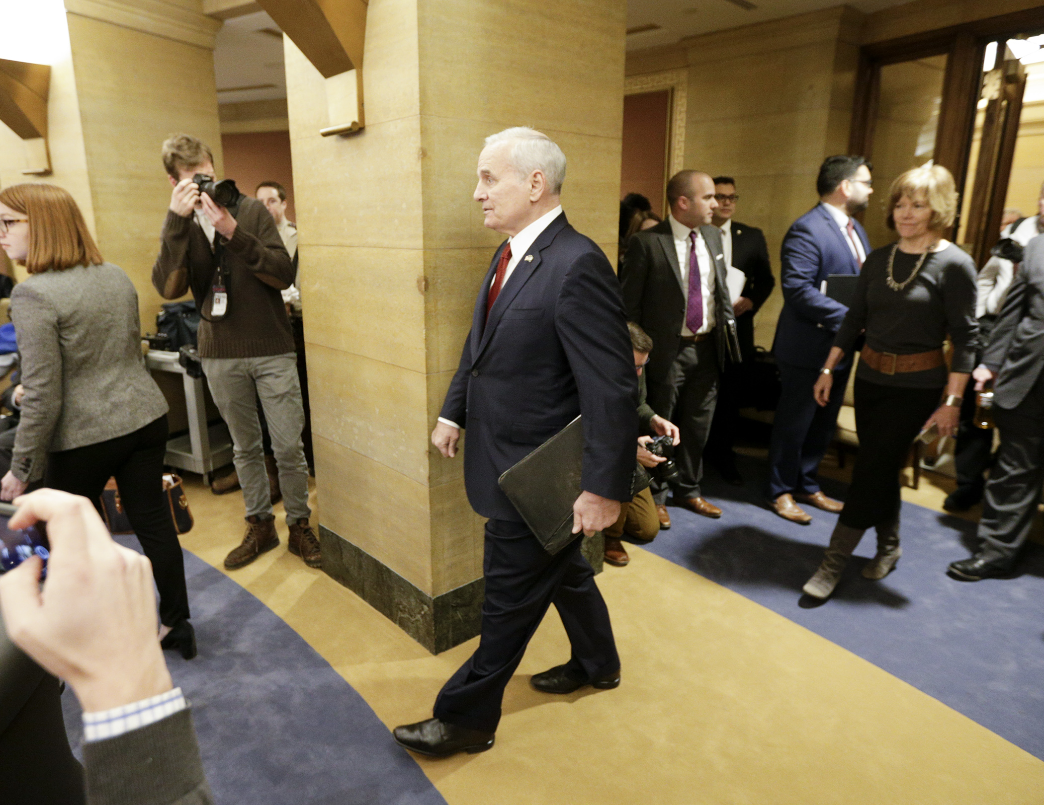 Gov. Mark Dayton enters a State Capitol hearing room to deliver his biennial budget proposal. Photo by Paul Battaglia