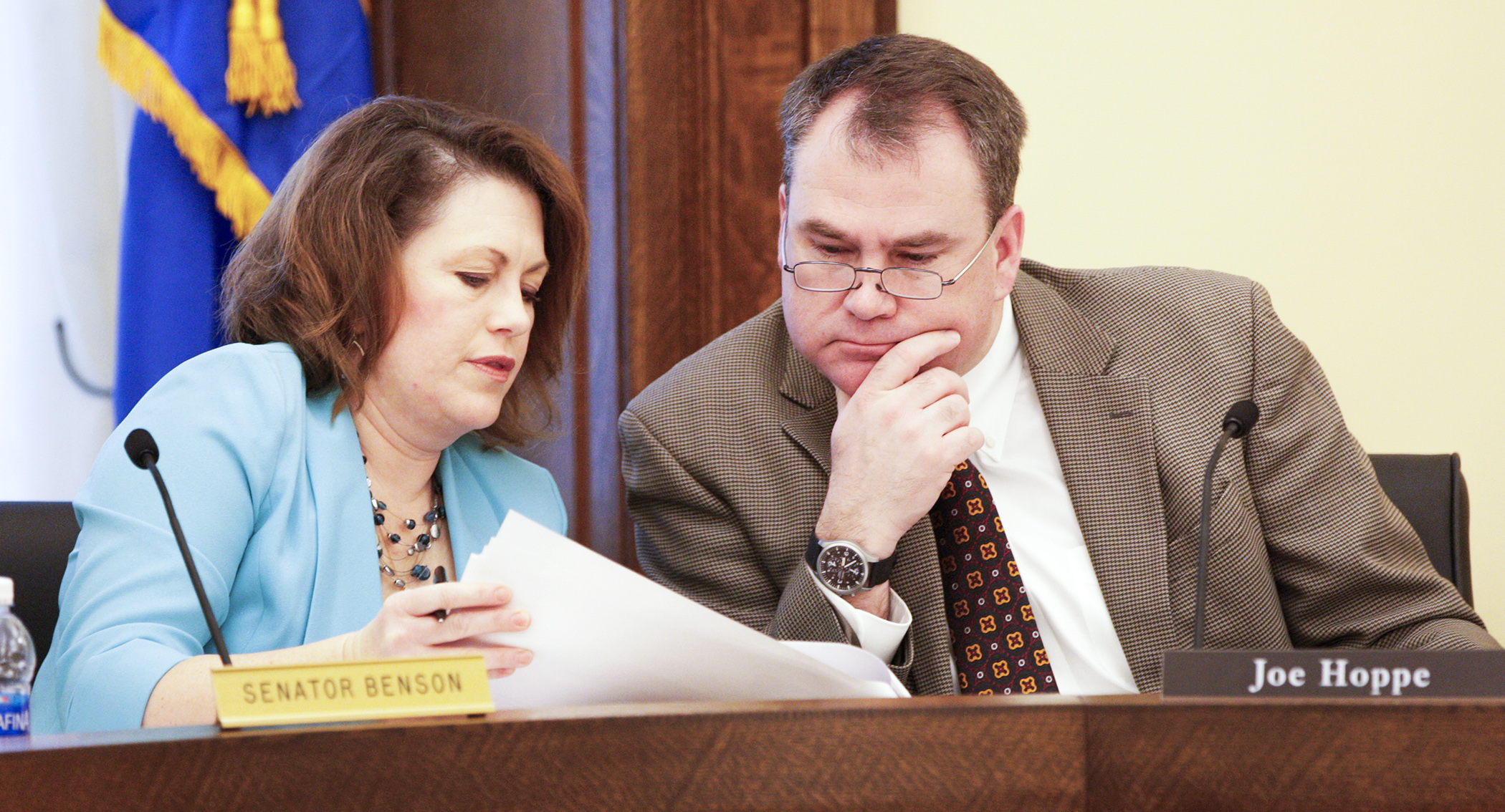 Rep. Joe Hoppe and Sen. Michelle Benson, co-chairs of the conference committee on SF1, confer as staff go through a side-by-side comparison of the House and Senate bills Jan. 24. Photo by Paul Battaglia
