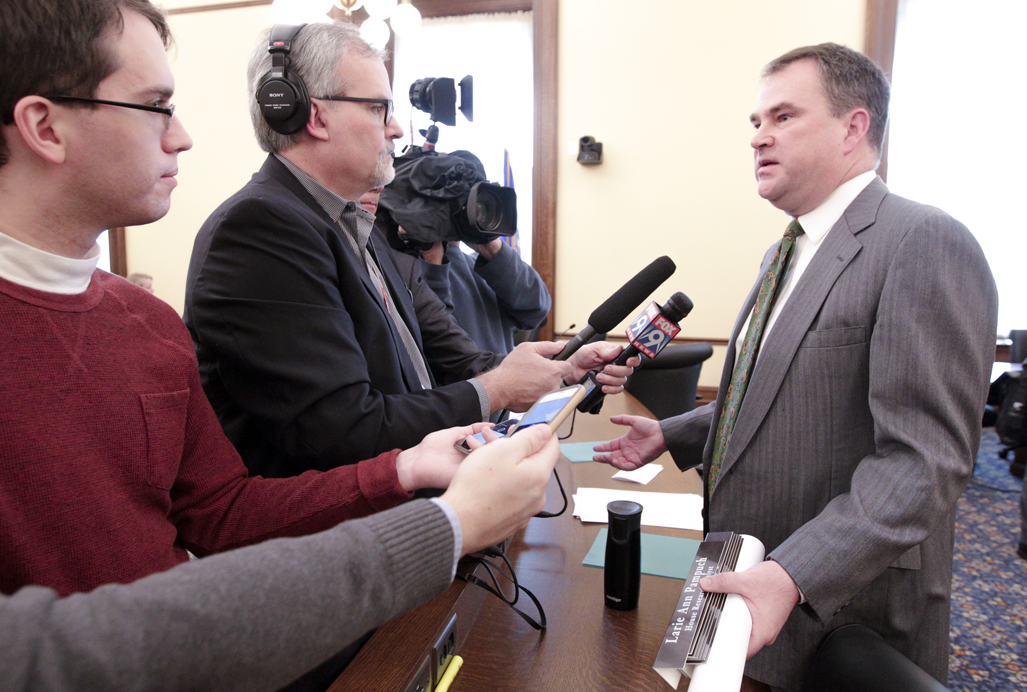Rep. Joe Hoppe, co-chair of the conference committee on HF1/SF1*, talks with the media after members reached agreement Jan. 25 on the bill to aid consumers hit by increases in health care premiums. Photo by Paul Battaglia