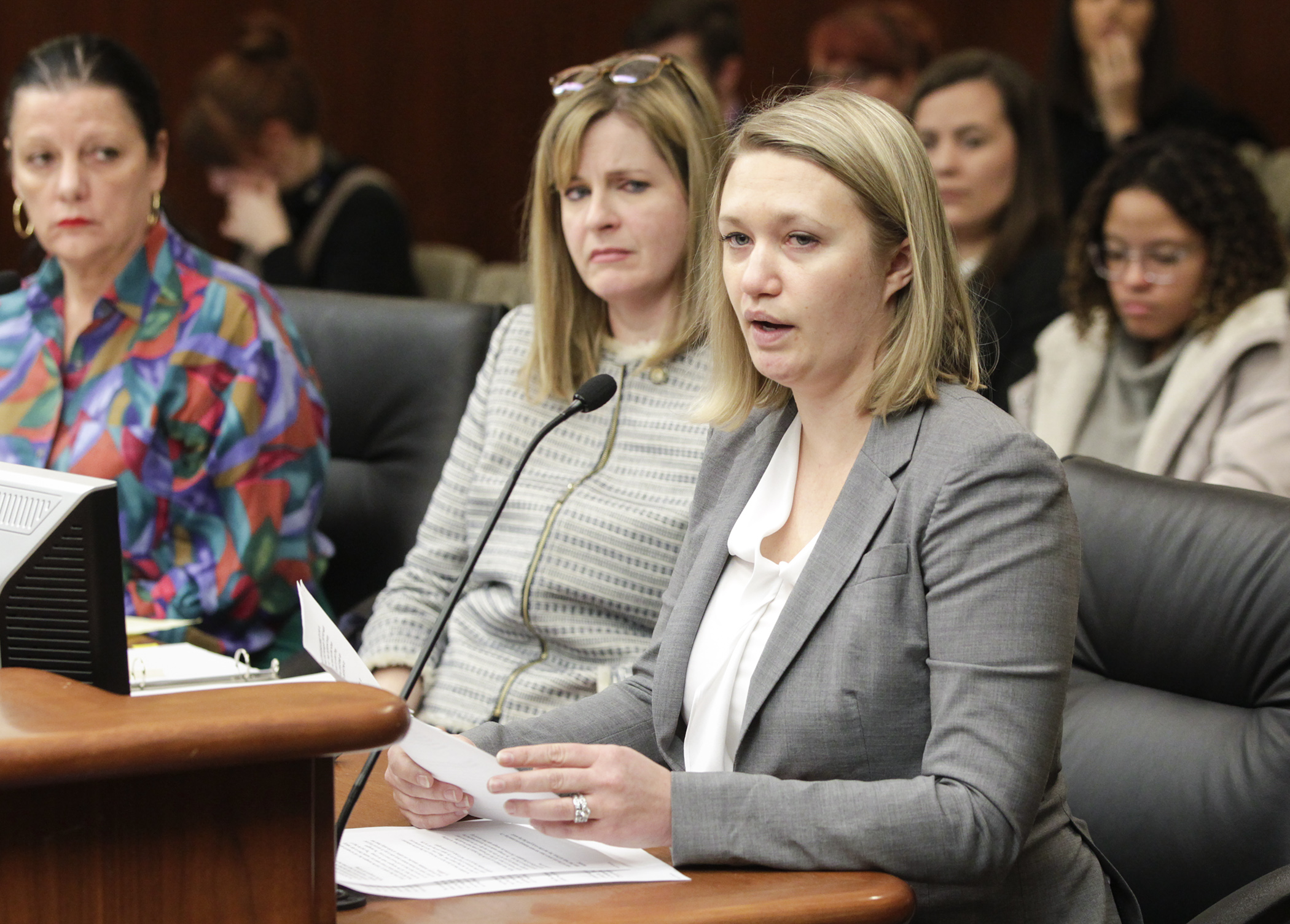 A testifier talks about being sexually harassed at her workplace during Feb. 7 testimony before the House Judiciary Finance and Civil Law Division. Members approved HF10, sponsored by Rep. Kelly Moller, left, to amend the definition of “sexual harassment” i