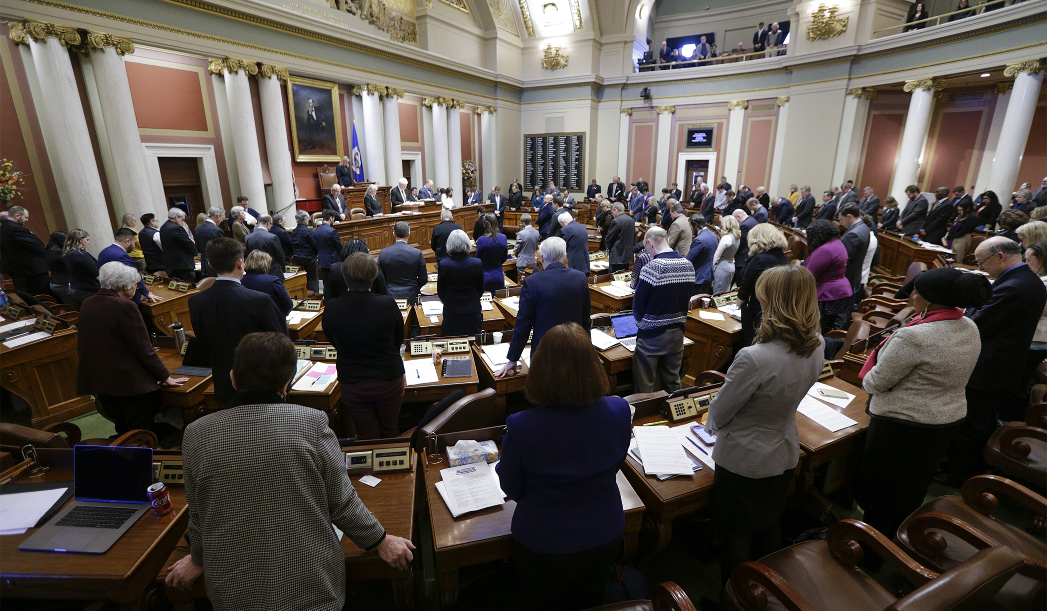 Members of the House stand Feb. 11 for a moment of silence in honor of the late Rep. Diane Loeffler, who passed away in November. Photo by Paul Battaglia