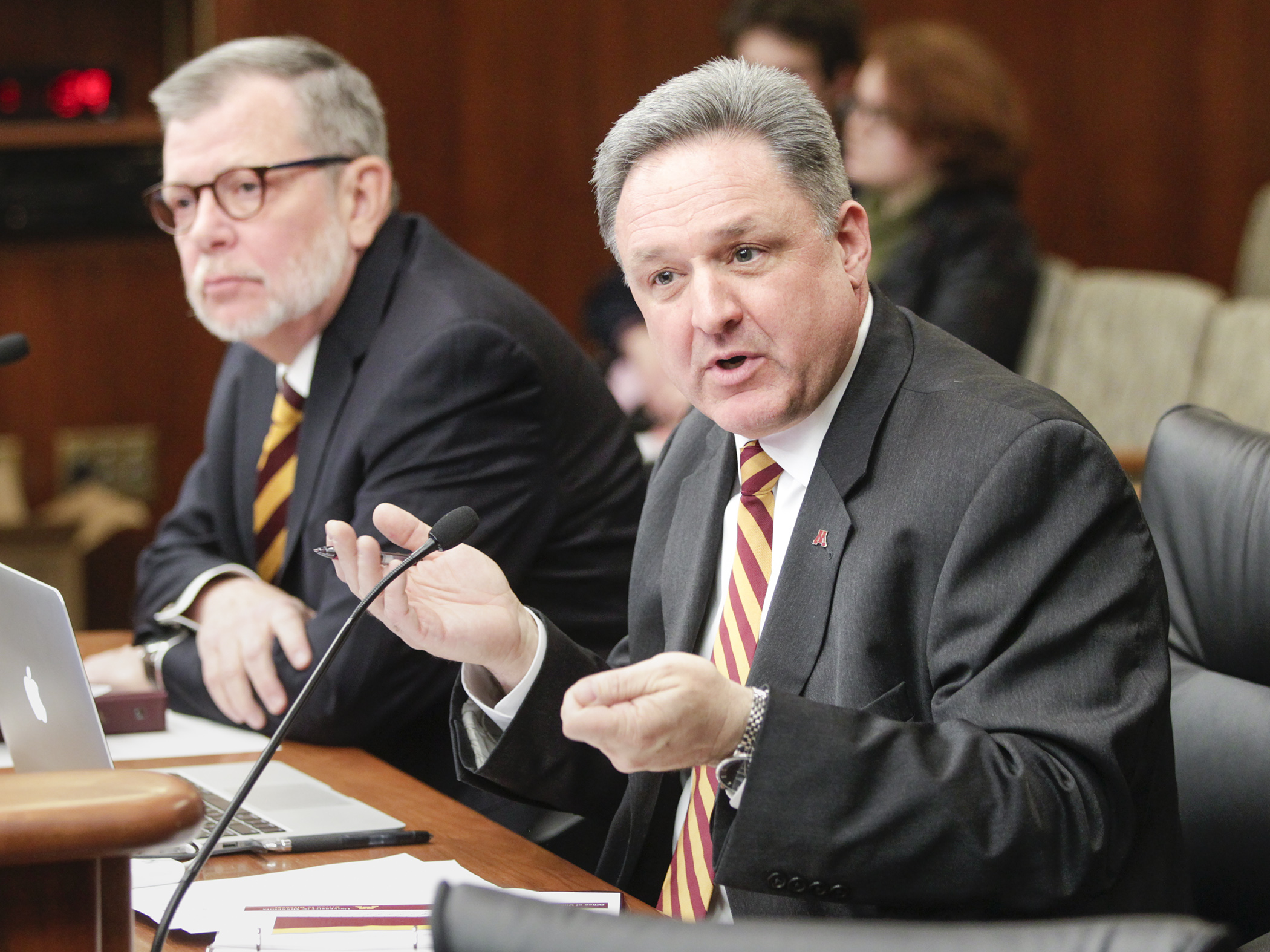 Brian Burnett, University of Minnesota senior vice president, testifies Feb. 12 in the House Higher Education Finance and Policy Division. Looking on is Eric Kaler, the university's president. Photo by Paul Battaglia