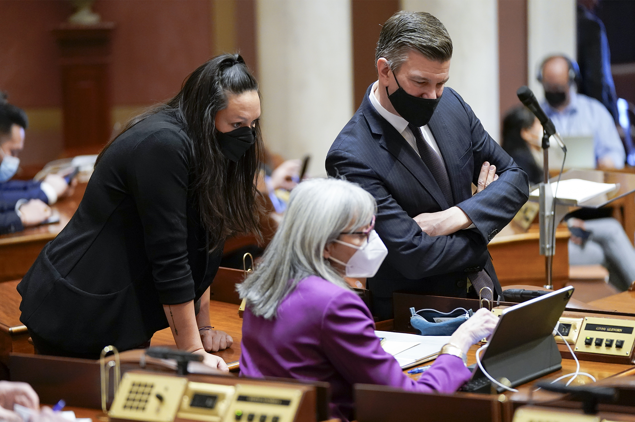 House Majority Leader Ryan Winkler, Rep. Heather Keeler, left, and Rep. Ginny Klevorn look at the state's newly-released legislative and congressional maps during the Feb. 15 floor session. (Photo by Paul Battaglia)