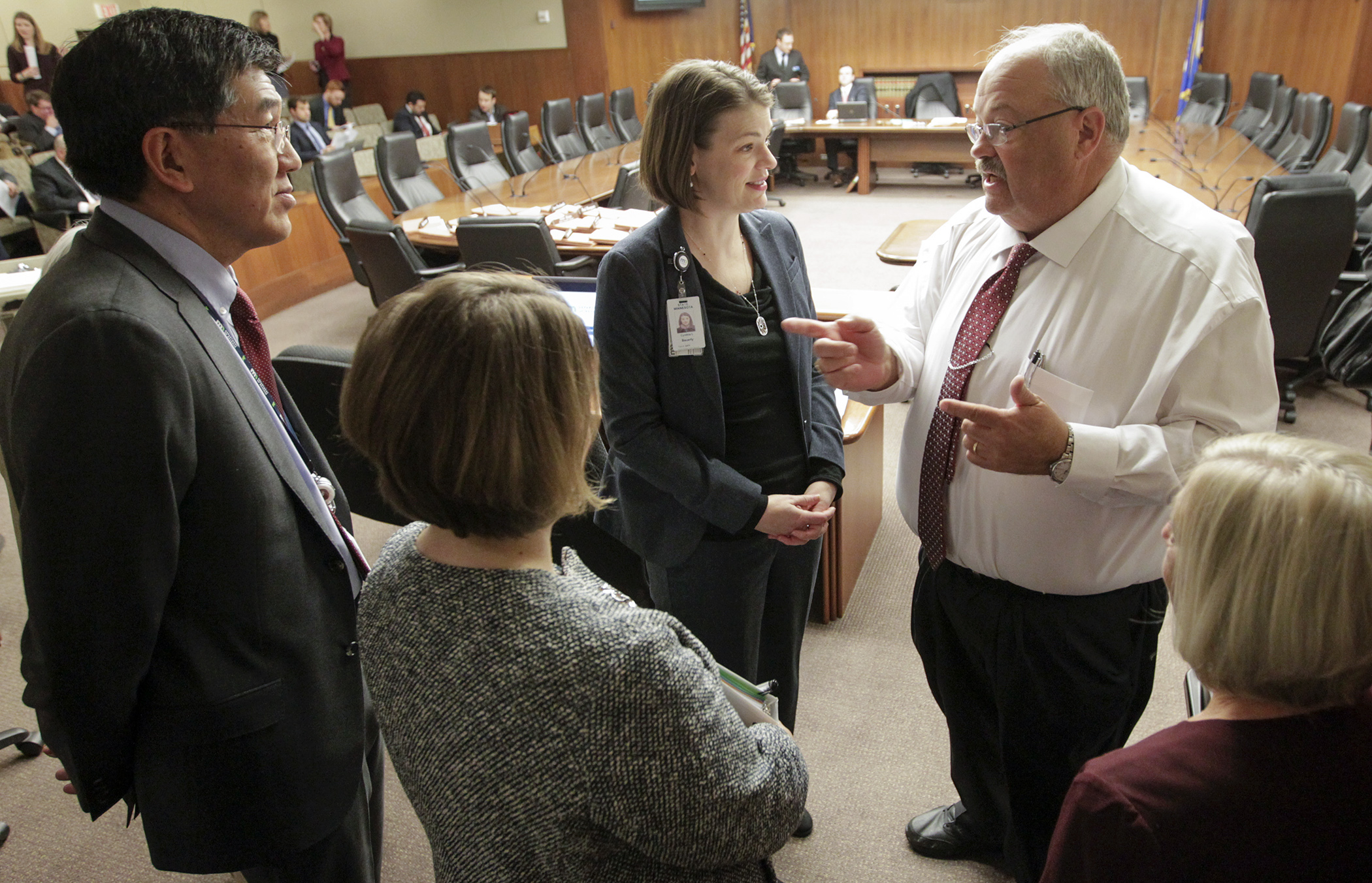 Chair Greg Davids, right, talks with Revenue Commissioner Cynthia Bauerly, center, and her staff before the House Taxes Committee meeting Feb. 20. Photo by Paul Battaglia