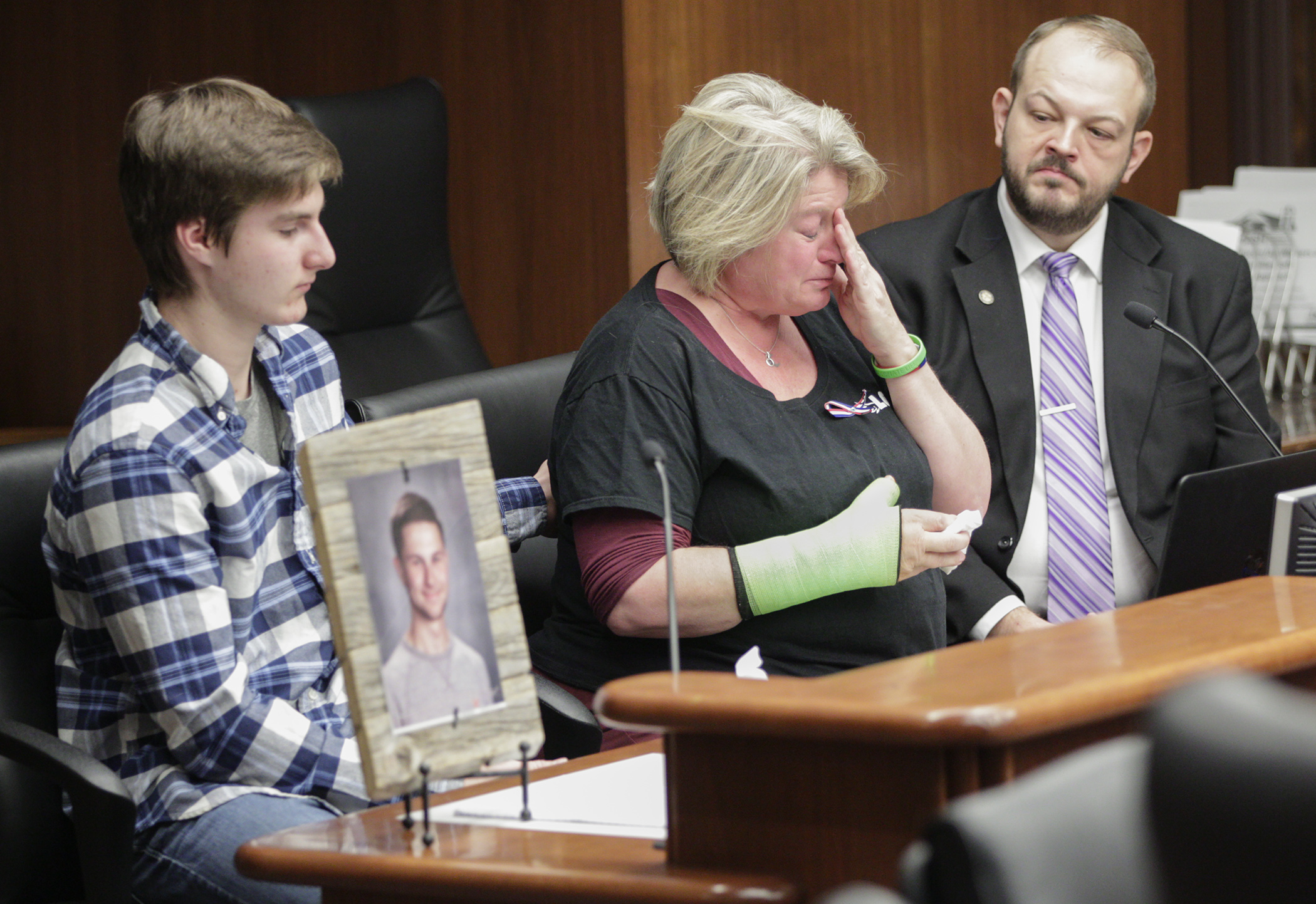 Michele Gran, whose 18-year-old son, Landon, was killed in an August 2019 farm accident, provides emotional testimony Feb. 20 to the House Agriculture and Food Finance and Policy Division. A bill sponsored by Rep. Jeff Brand, right, seeks to establish a farm safety grant program. Photo by Paul Battaglia