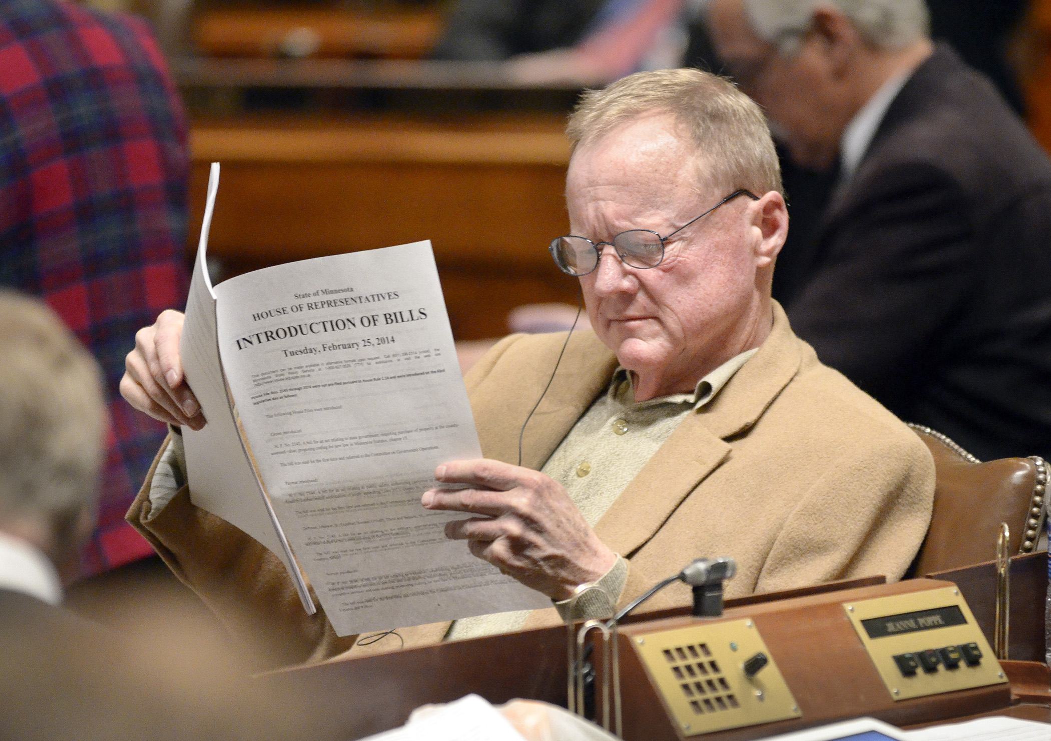 Rep. David Dill checks out the day's bill introductions during the 2014 session. Photo by Andrew VonBank