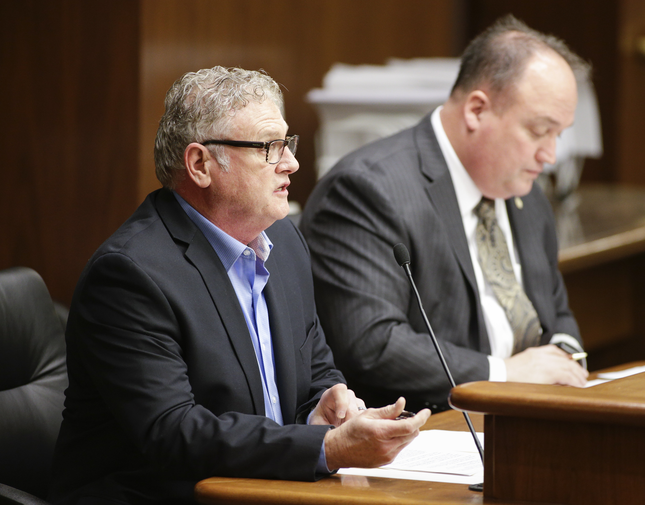 Joey Matthews testifies in the House Education Finance Division on HF1363, sponsored by Rep. John Huot, right, which would provide grants are for school districts to hire additional school support services personnel. Photo by Paul Battaglia