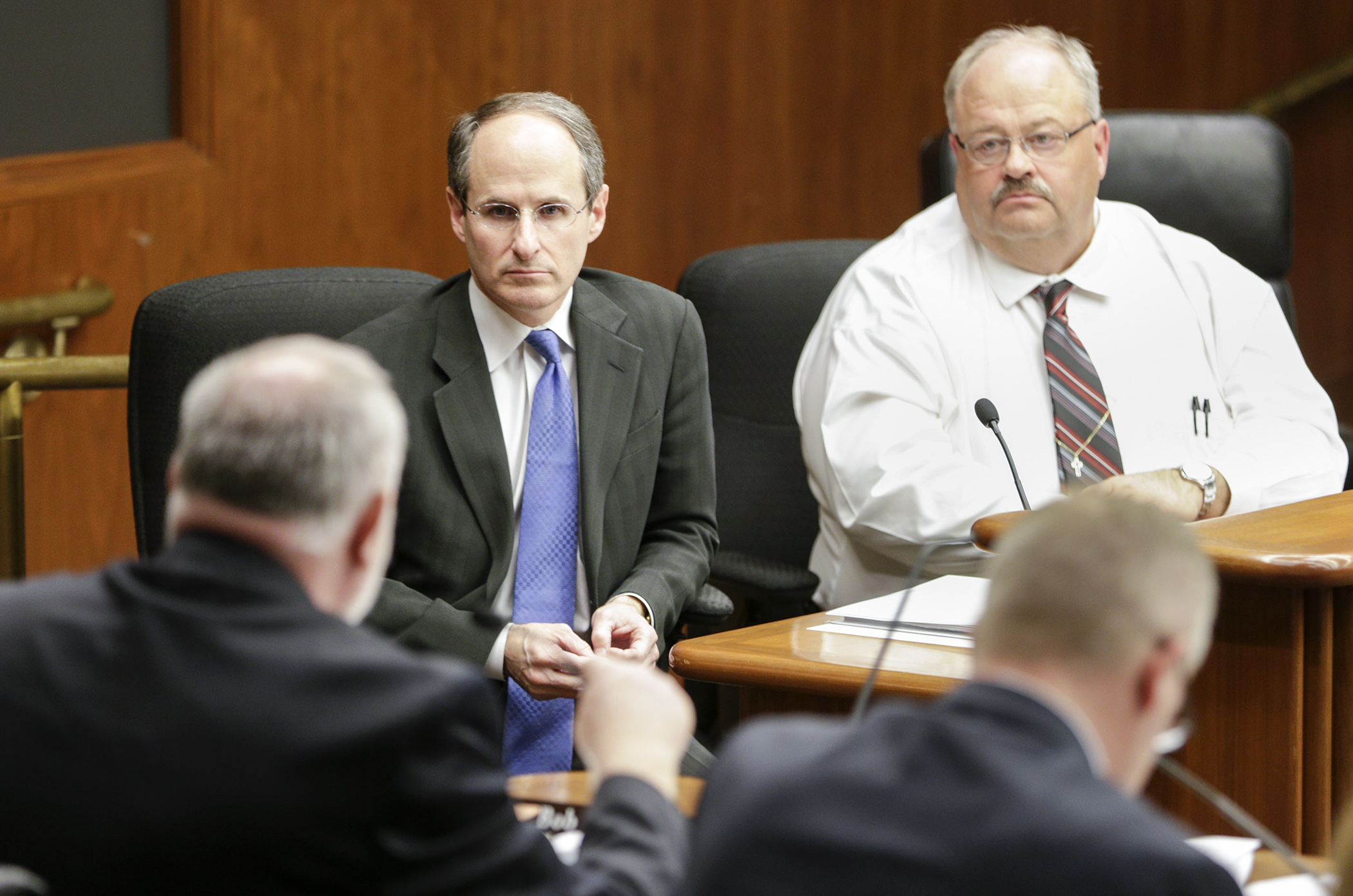 Commerce Commissioner Mike Rothman, center, listens as Rep. Bob Loonan asks a question during discussion of HF5 by the House Commerce and Regulatory Reform Committee March 1. Sponsored by Rep Greg Davids, right, the bill would, in part, create the Minnesota Premium Security Plan to provide reinsurance for health carriers operating in the individual health insurance market in Minnesota. Photo by Paul Battaglia