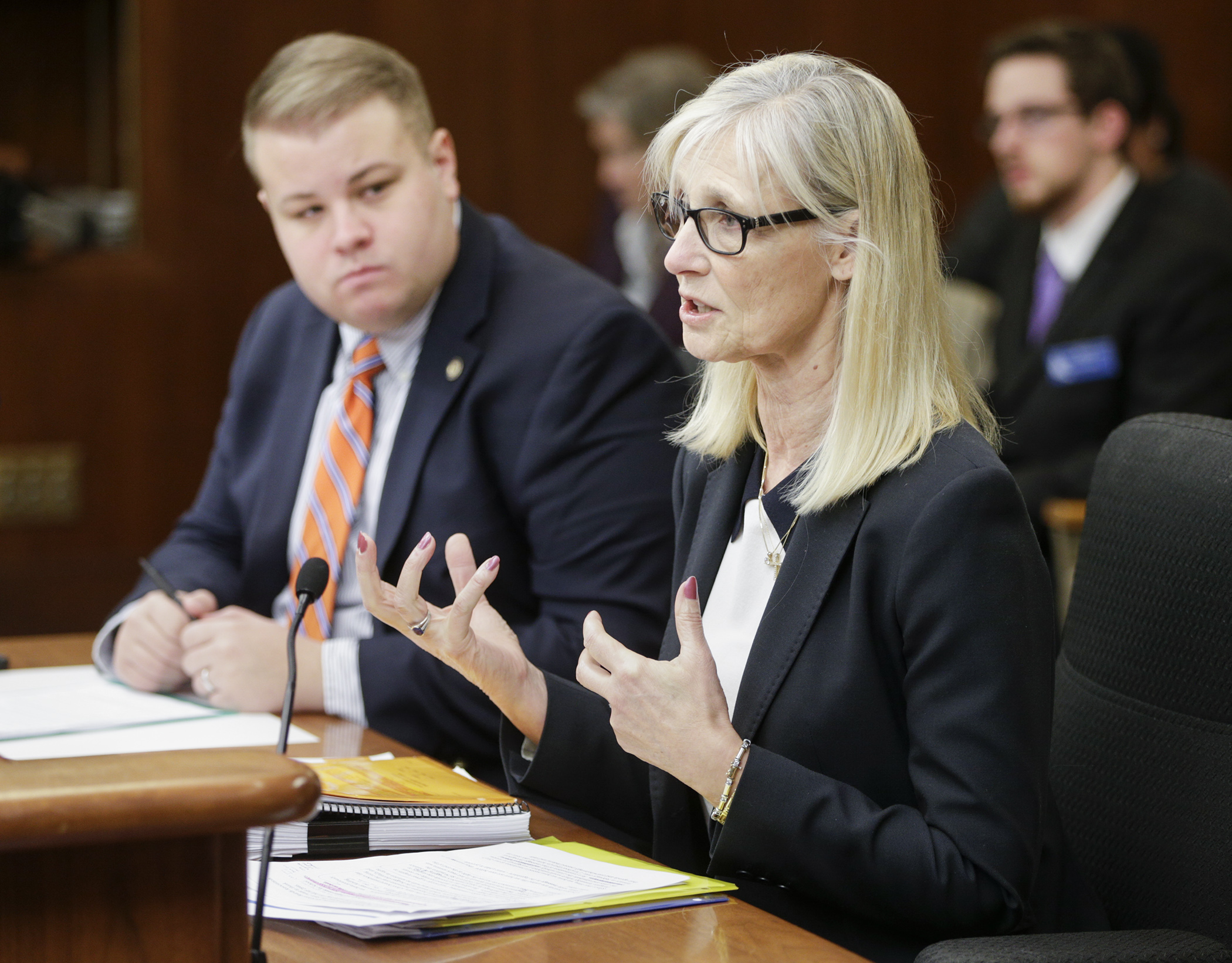 Denise Dittrich, associate director of government relations for the Minnesota School Boards Association, speaks to the House Education Innovation Policy Committee March 1 in favor of HF2846 sponsored by Rep. Drew Christensen, left.