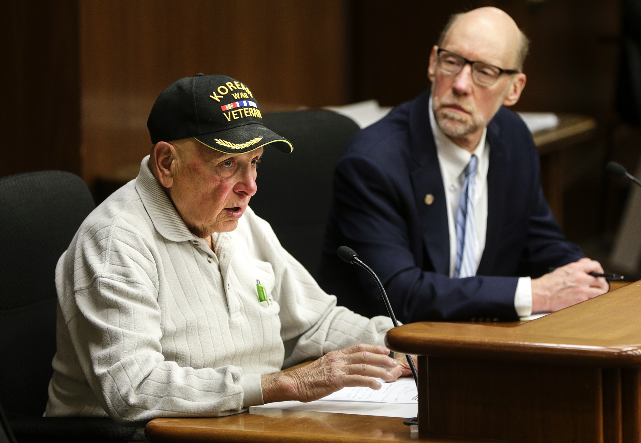 Korean War veteran Phil Tennebaum testifies March 5 before the House Veterans Affairs Division in favor of HF1123, sponsored by Rep. Jim Davnie, right, which would increase the homestead valuation exclusion for disabled veterans. Photo by Paul Battaglia
