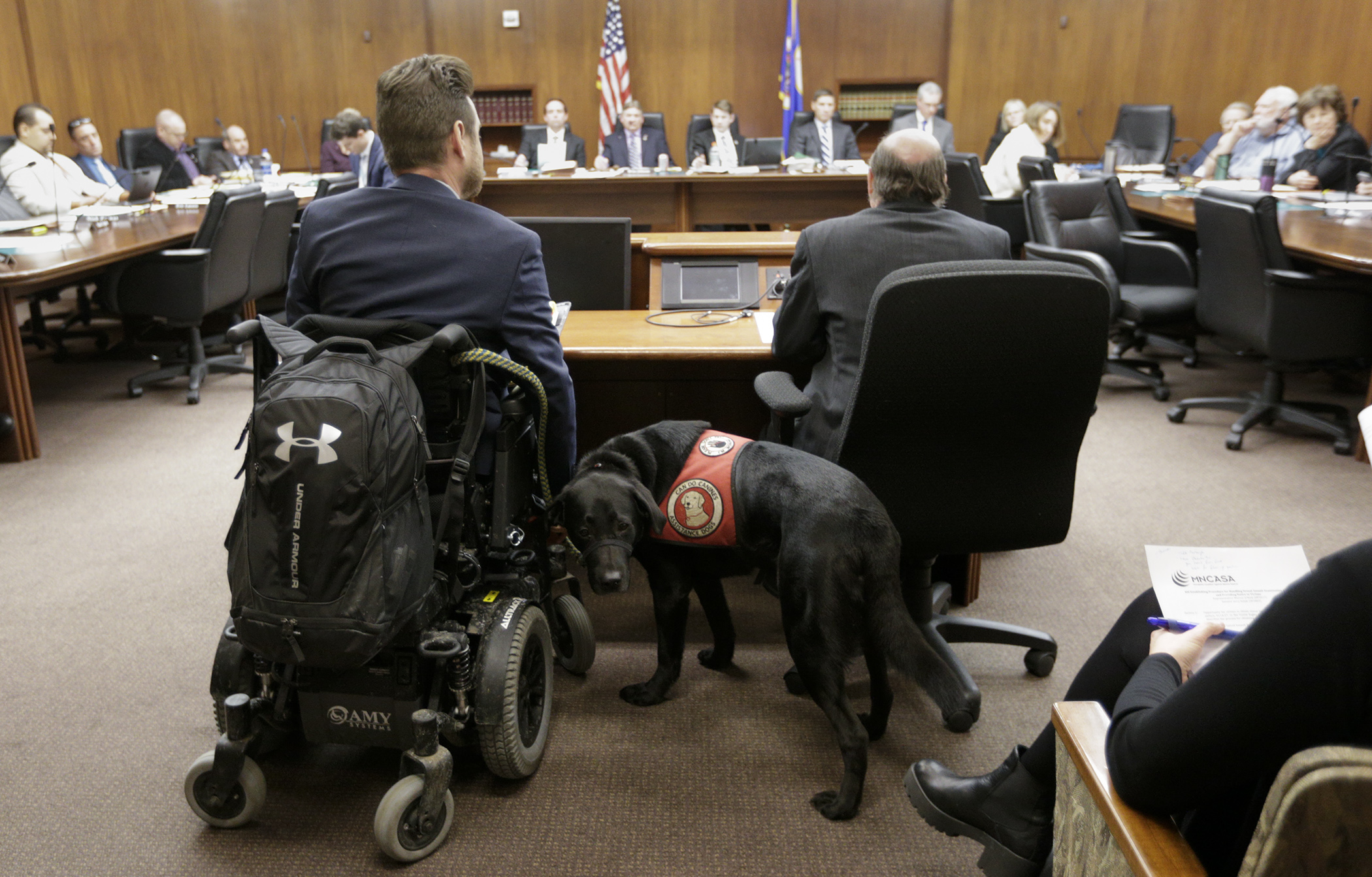 With his service dog, Porter, alongside, Chad Wilson, staff attorney with the Minnesota Disability Law Center, waits to testify March 7 before the House Public Safety and Security Policy and Finance Committee. Photo by Paul Battaglia