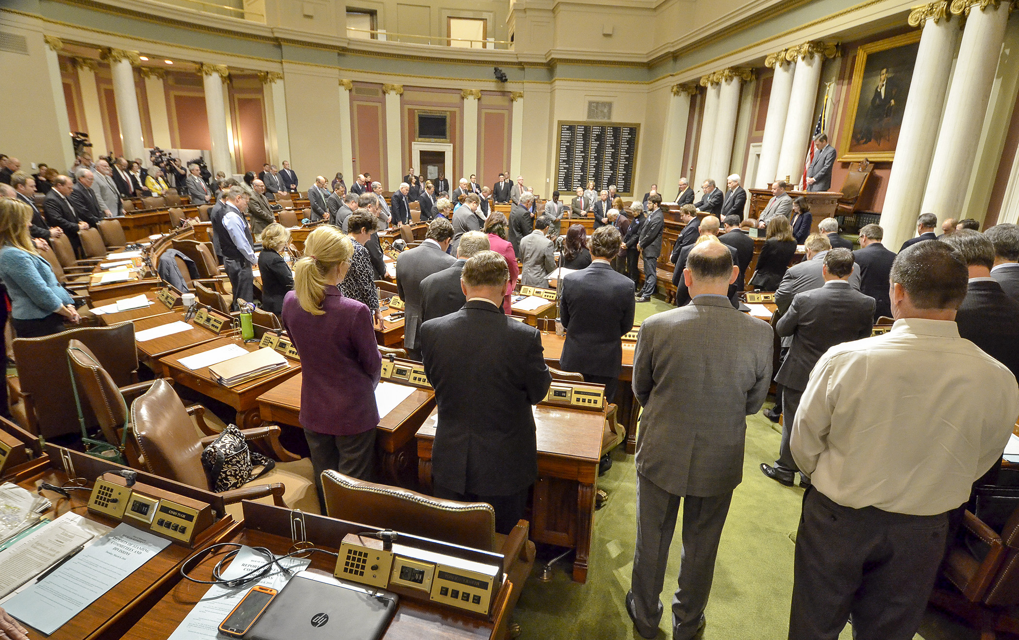 Members of the House of Representatives stand for the invocation on the opening day of the 2016 legislative session. Photo by Andrew VonBank