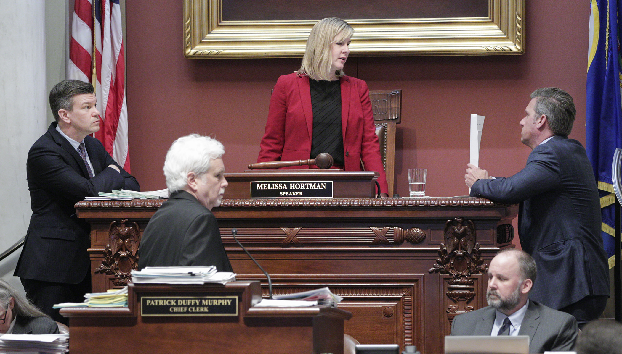 House Speaker Melissa Hortman (middle) and Majority Leader Ryan Winkler (left) talk with Minority Leader Kurt Daudt during an early March floor session. House Photography file photo