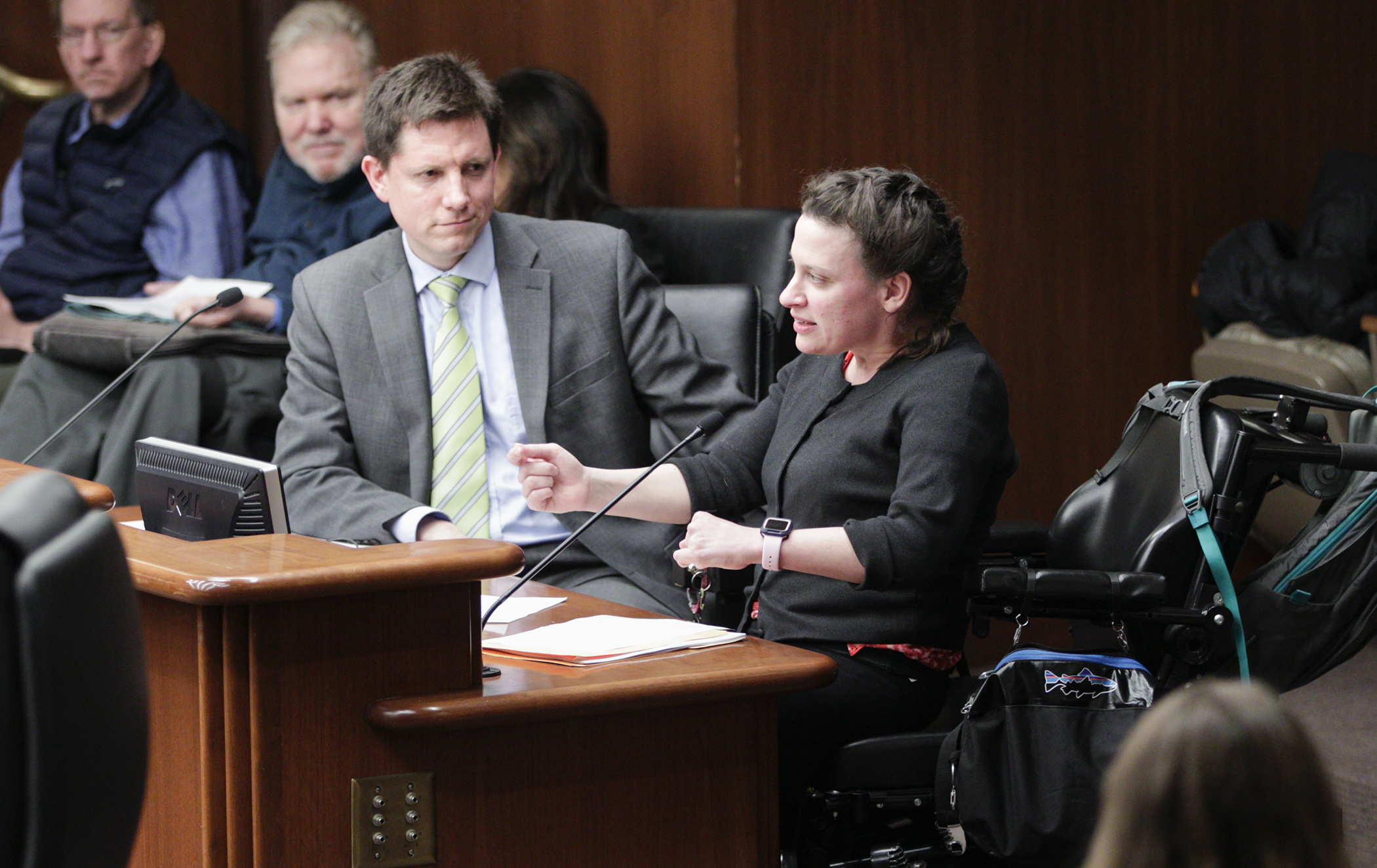Katrina Simons, a personal care assistant client, testifies on HF3654 before the House Long-Term Care Division March 9. Sponsored by Rep. Todd Lippert, left, the bill would provide for new PCA rate reform. Photo by Paul Battaglia