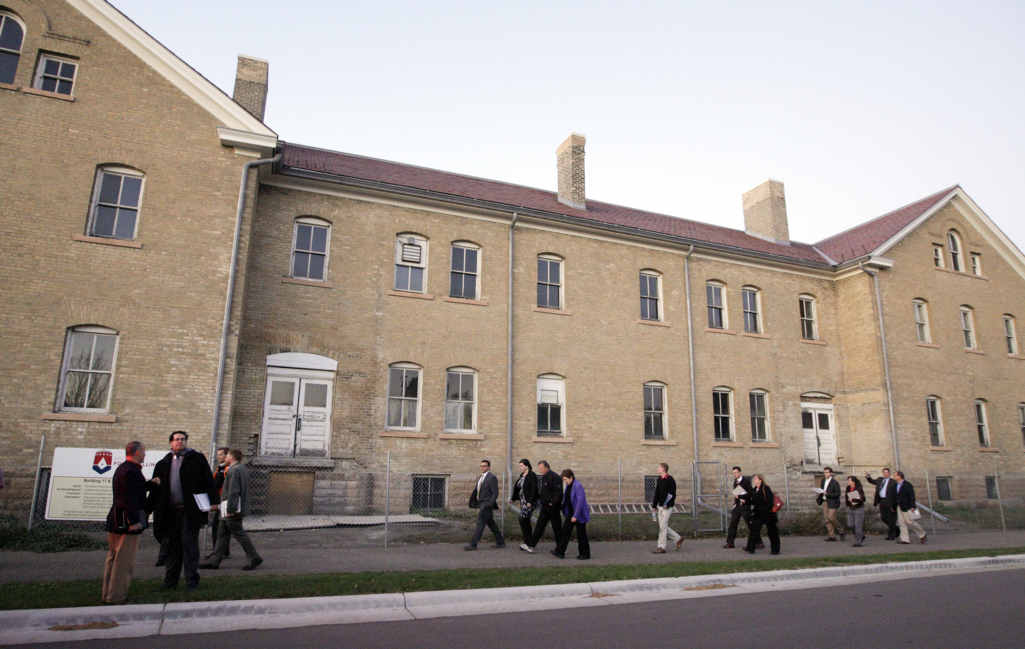 On Oct. 15, 2015, members and staff of the House Capital Investment Committee walk by the historic cavalry barracks at Fort Snelling which the Minnesota Historical Society proposes to rehabilitate as the new visitor center. Photo by Paul Battaglia
