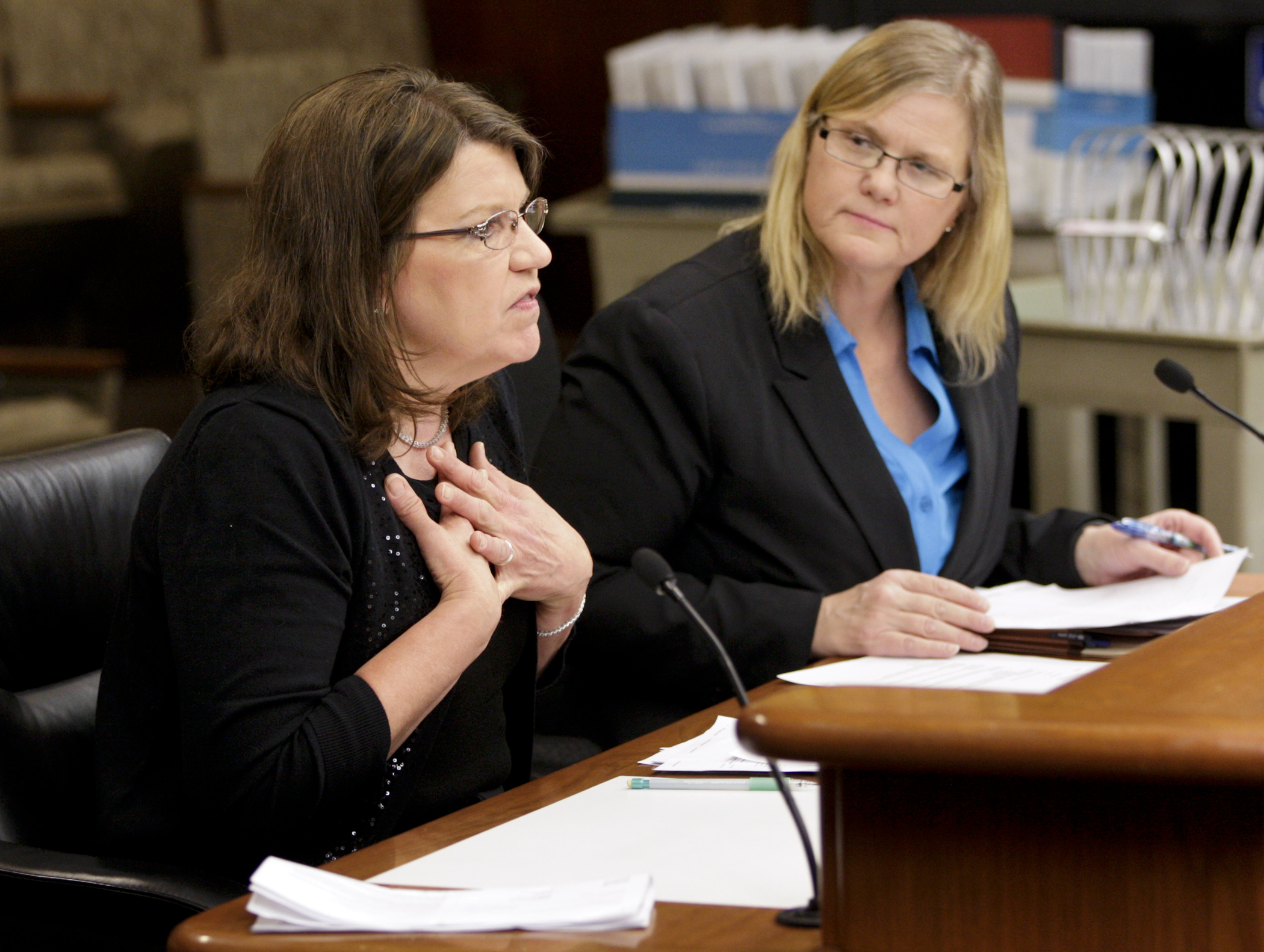 Patricia Maahs relates her personal story March 11 while speaking in support of HF889, sponsored by Rep. Debra Hilstrom, right, which would expand the definition of fifth-degree criminal sexual conduct. Photo by Paul Battaglia