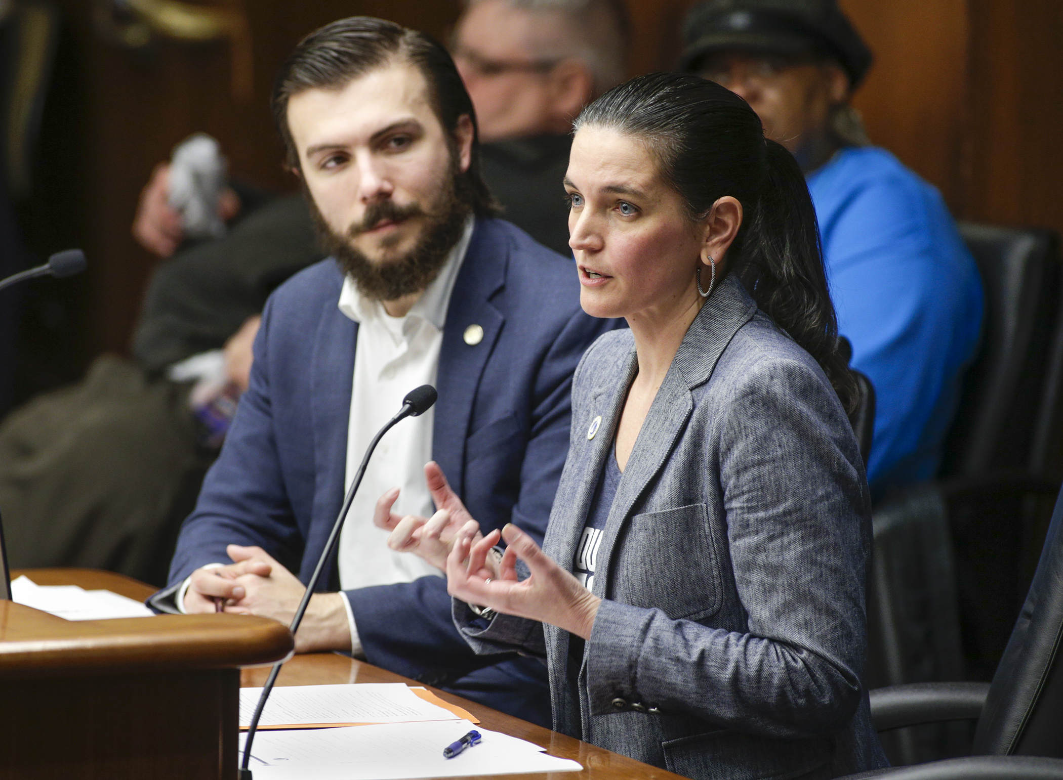 Wendy Underwood, vice president of advocacy with Catholic Charities of St. Paul and Minneapolis, testifies March 11 before the House Health and Human Services Finance Division on HF1805, sponsored by Rep. Hunter Cantrell, left. Photo by Paul Battaglia