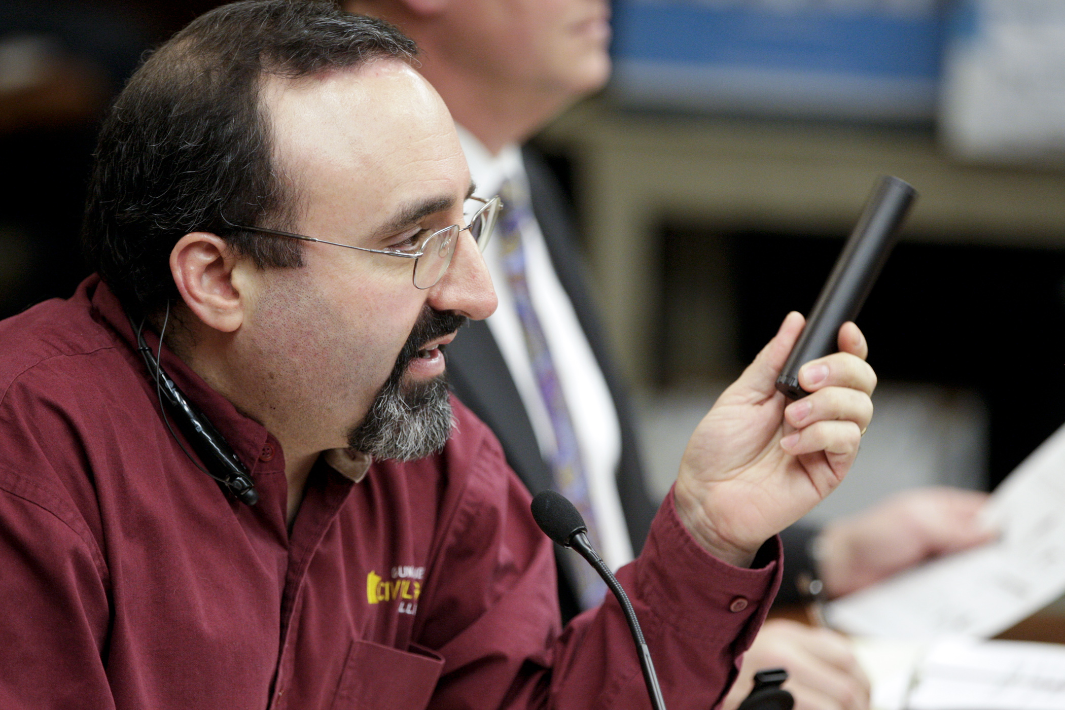 Andrew Rothman, president of the Gun Owners Civil Rights Alliance, holds a suppressor during his March 12 testimony on a bill to allow possession and use of suppressors after completing the necessary federal certification process. Photo by Paul Battaglia