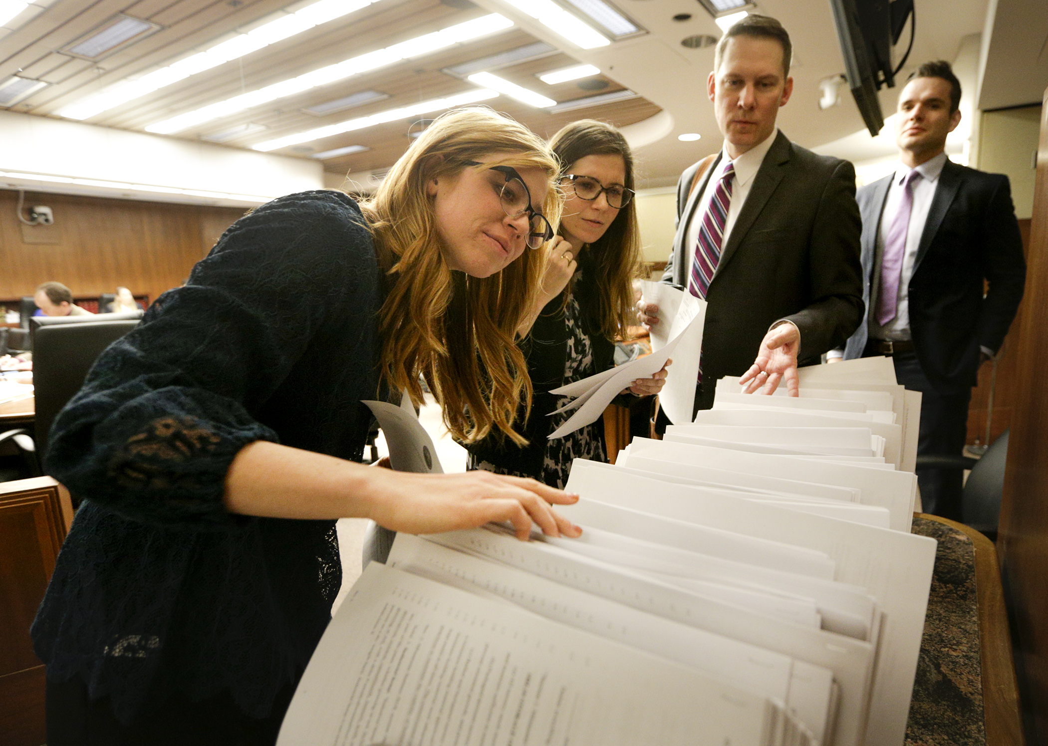 Audience members at the March 12 meeting of the House Agriculture and Food Finance and Policy Division begin the annual task of gathering large quantities of paper as the division begins to develop an omnibus bill. Photo by Paul Battaglia