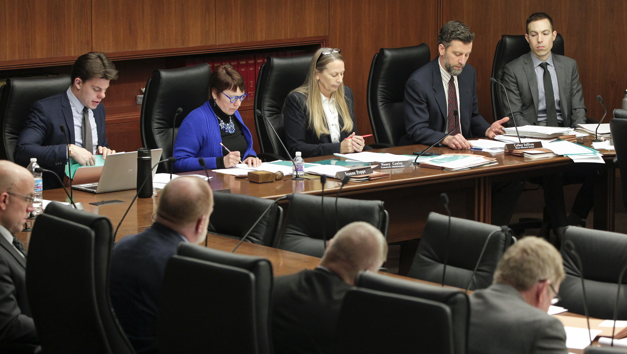 Members and staff of the House Agriculture and Food Finance and Policy Division follow along March 12 as House Research Department analyst Colbey Sullivan, second from right, does a walkthrough of the omnibus agriculture policy bill. Photo by Paul Battaglia