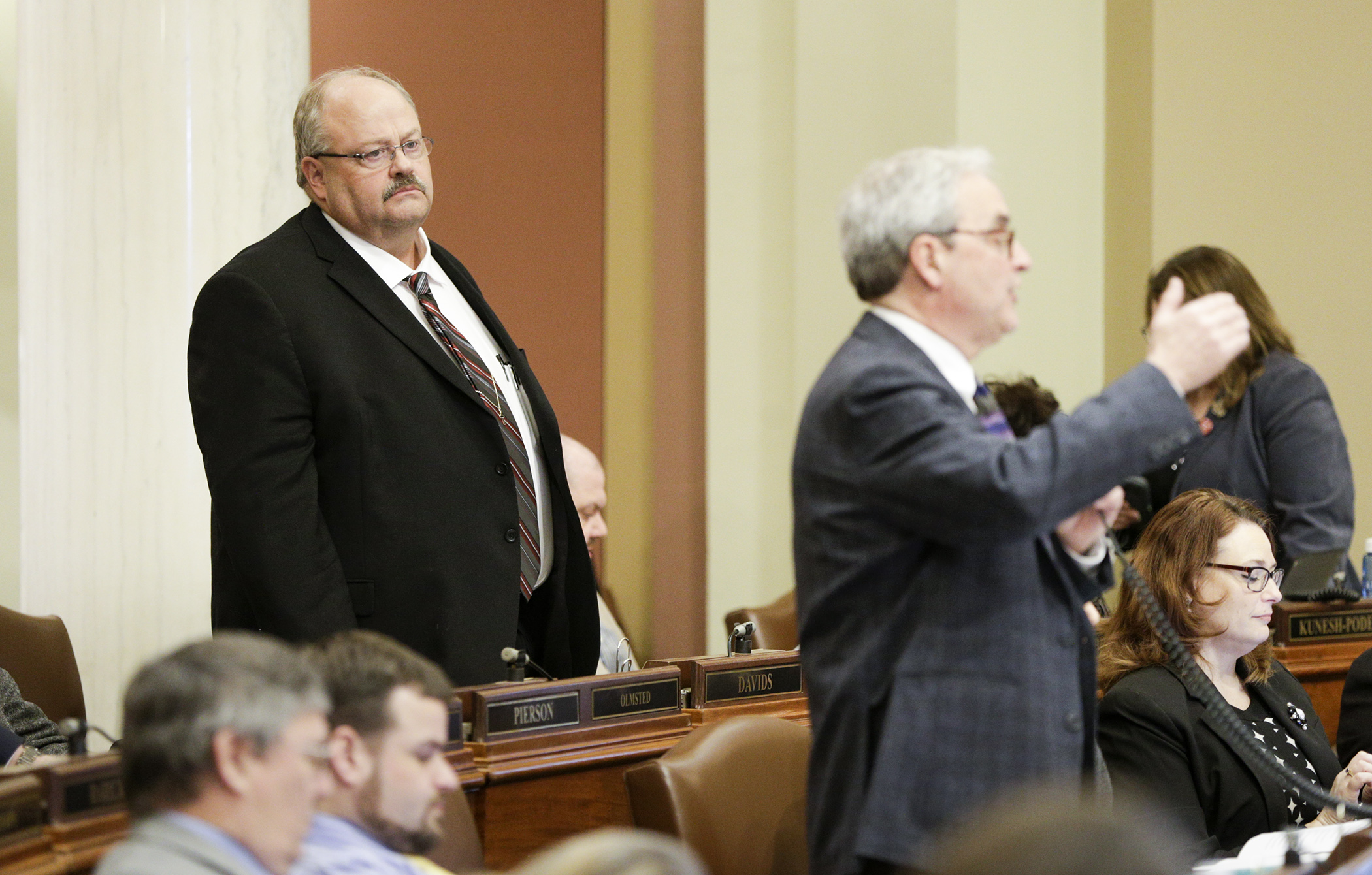 Rep. Greg Davids, left, listens as Rep. Clark Johnson responds March 13 to a question about HF5, which Davids sponsors. In part, it would create the Minnesota Premium Security Plan, which would provide reinsurance for health carriers operating in the state’s individual health insurance market. Photo by Paul Battaglia