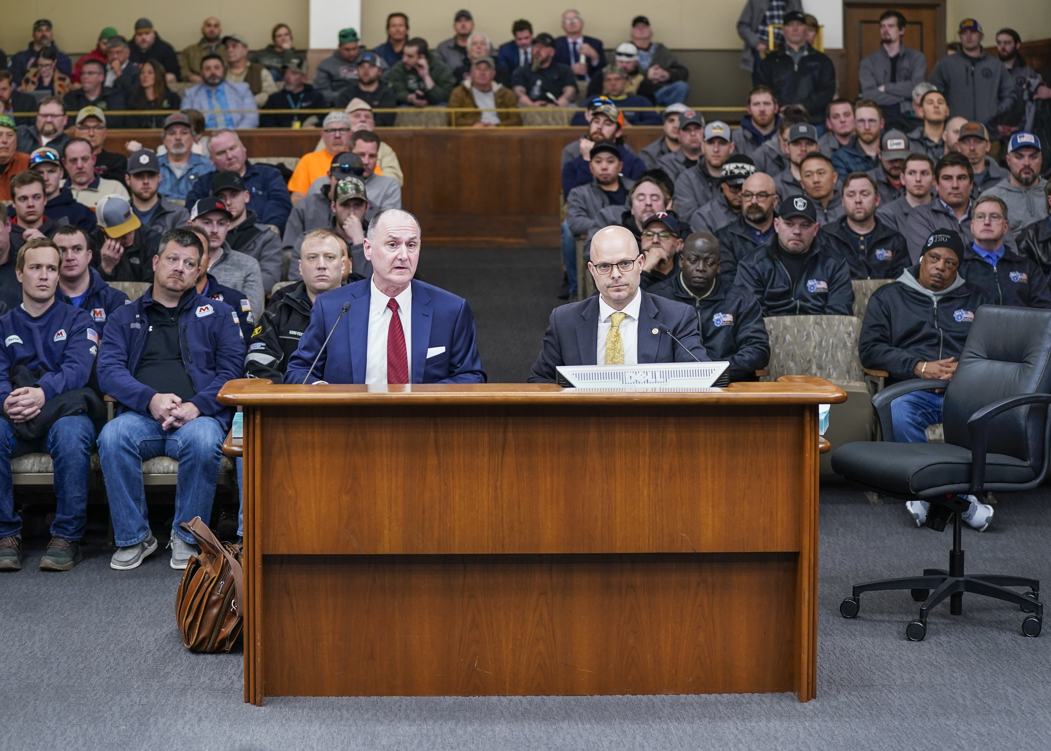 Representing the Minnesota Building and Construction Trades Council, and in a room filled with industry workers, Chris DeLaForest, left, testifies March 14 in support of HF10. Rep. Dave Lislegard, right, sponsors the bill. (Photo by Catherine Davis)