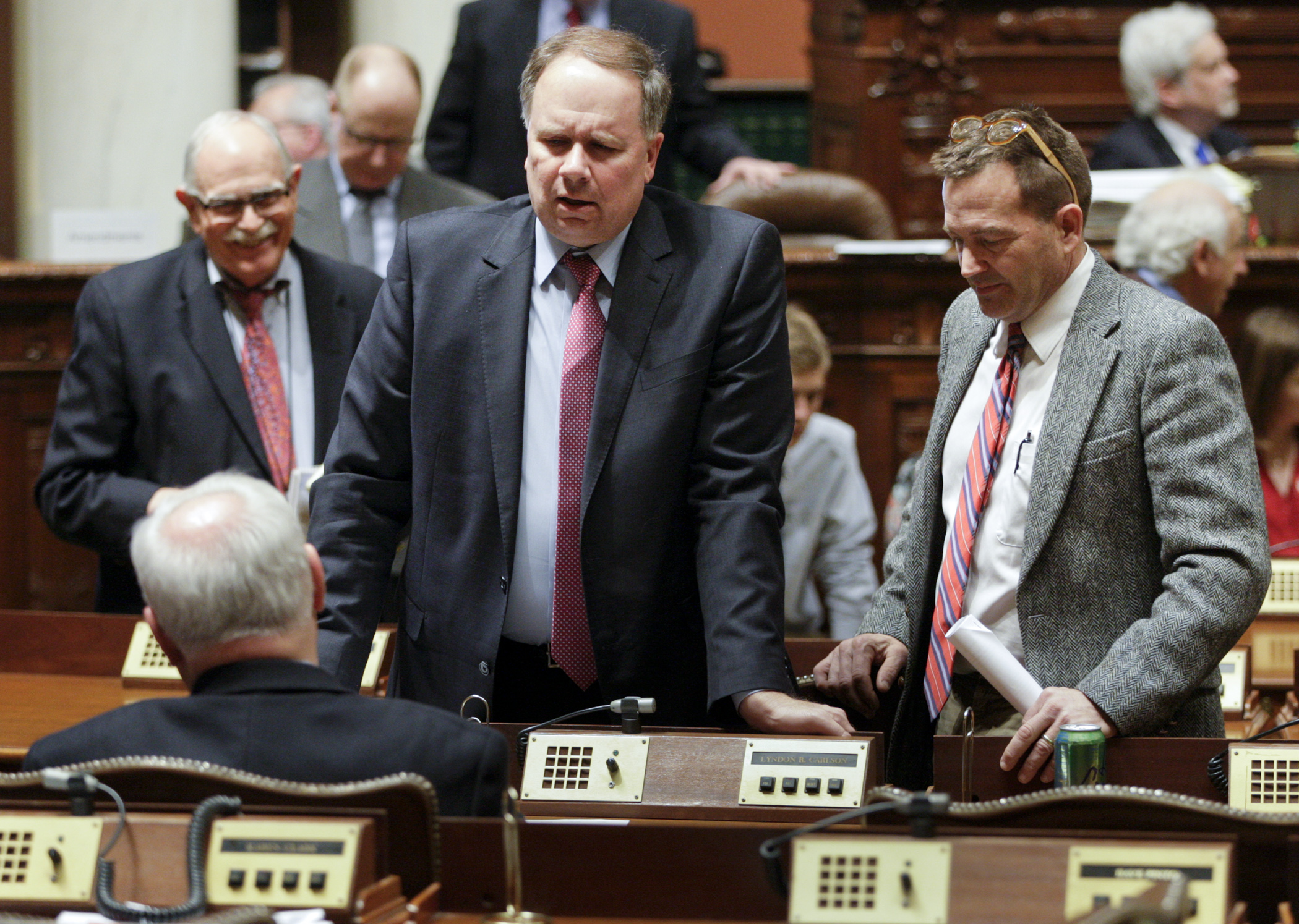 Rep. Jim Knoblach, center, confers with Reps. Lyndon Carlson Sr., left, and Leon Lillie after the March 16 House Floor session. Photo by Paul Battaglia