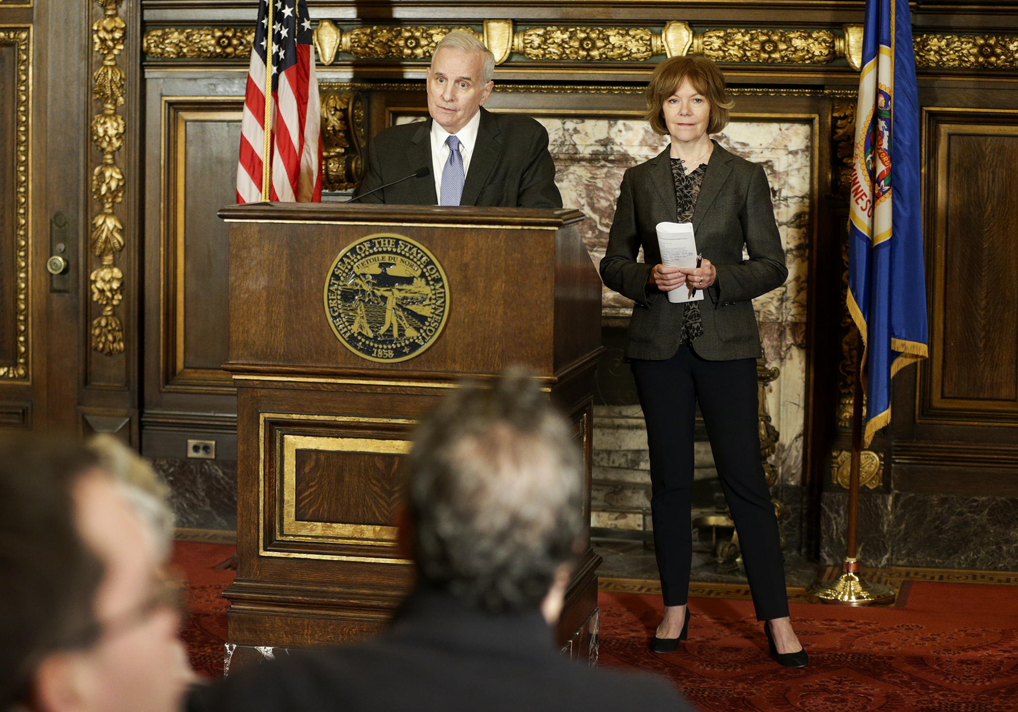 Gov. Mark Dayton and Lt. Gov. Tina Smith release their supplemental budget at a March 17 news conference. The governor proposes to spend an additional $100 million on voluntary pre-K programs and keep $200 million in reserve. Photo by Paul Battaglia