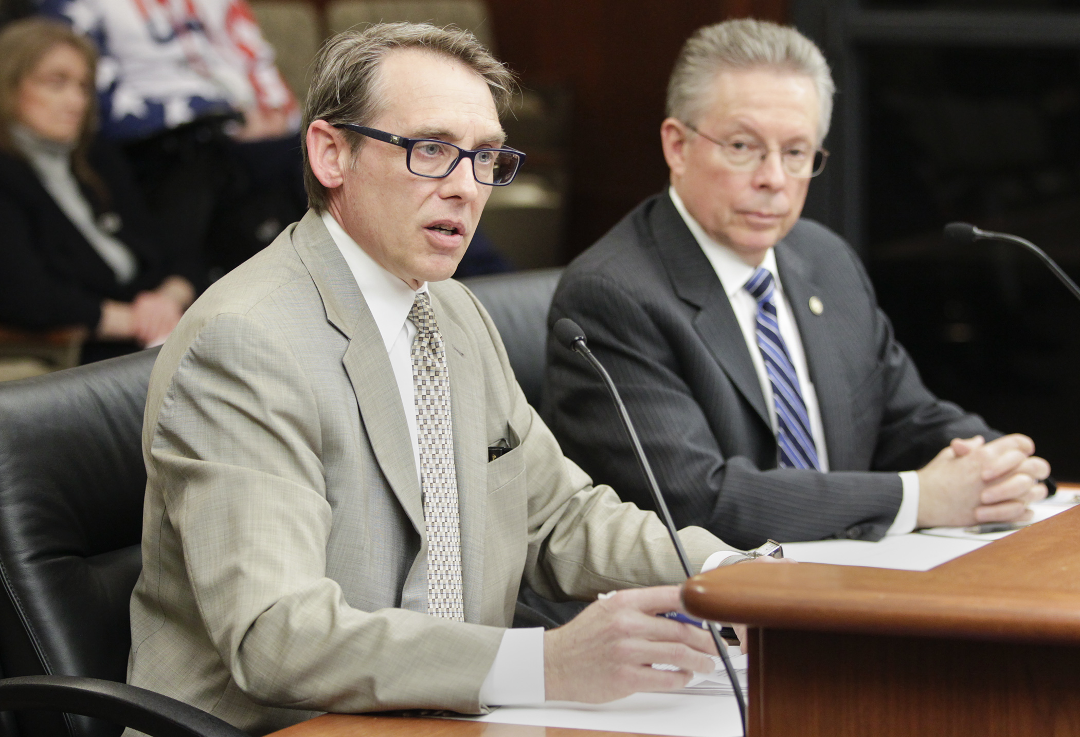 Lobbyist Jim Hirst testifies in the House transportation division on HF1008, sponsored by Rep. Steve Elkins, right, which would in part, modify fees related to motor vehicles as well as driver’s licenses and identification cards. Photo by Paul Battaglia