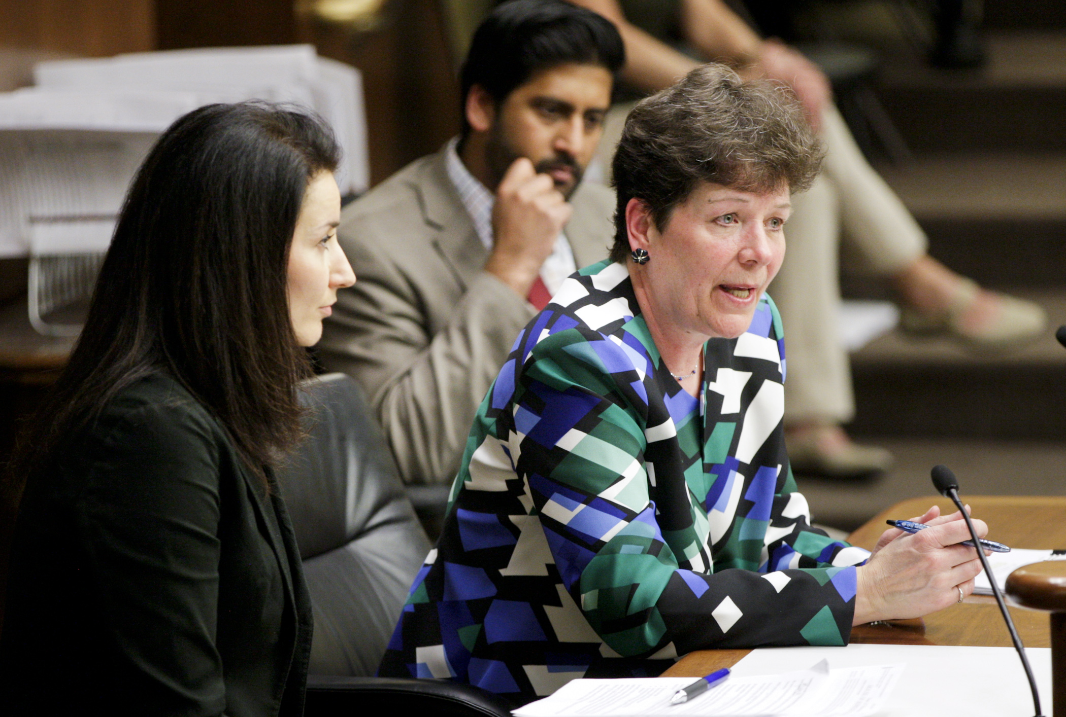 At a March 24 meeting of the House Higher Education Policy and Finance Committee, Rep. Peggy Bennett answers a question during testimony on her bill, HF1170, which would provide for a teacher shortage loan forgiveness program. Photo by Paul Battaglia