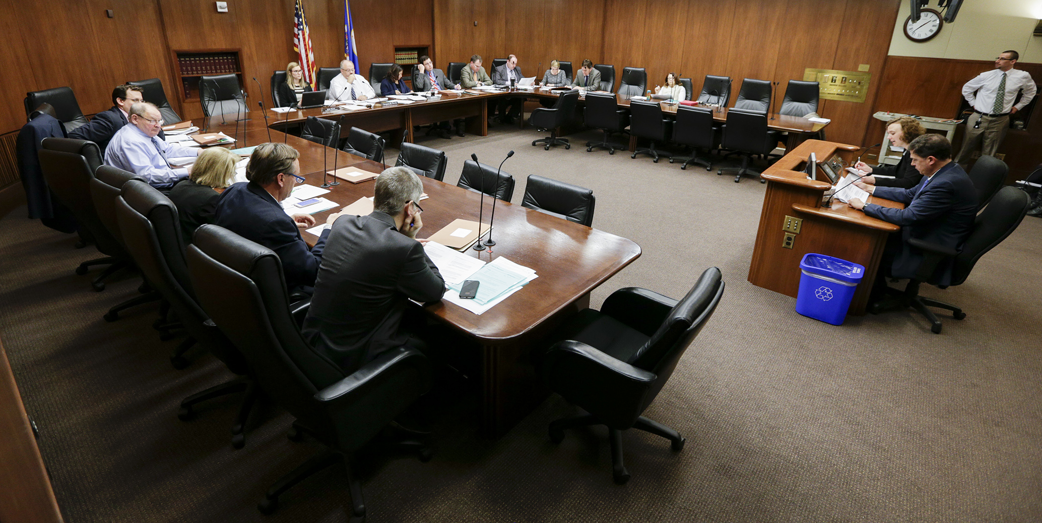 Members of the conference committee on HF5 listen to staff do a side-by-side comparison of the House and Senate bills during their first meeting March 24. Photo by Paul Battaglia