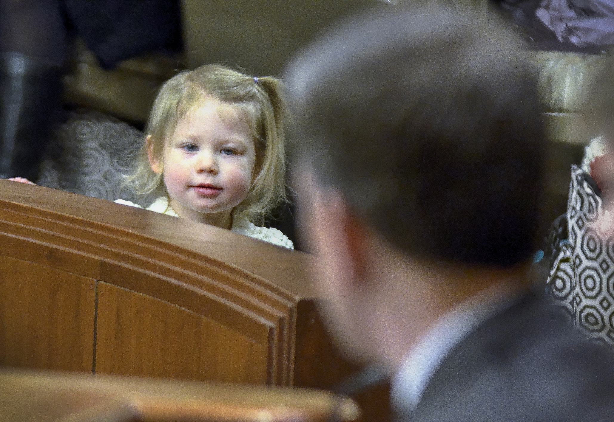 Ada Salmi-Bydalek, 2, watches from the gallery after her mother, Meredith, testified before the House Environment, Natural Resources and Agriculture Finance Committee March 25 in support of a bill sponsored by Rep. Ryan Winkler, foreground, that would prohibit sales of children’s products that contain harmful chemicals. Photo by Andrew VonBank
