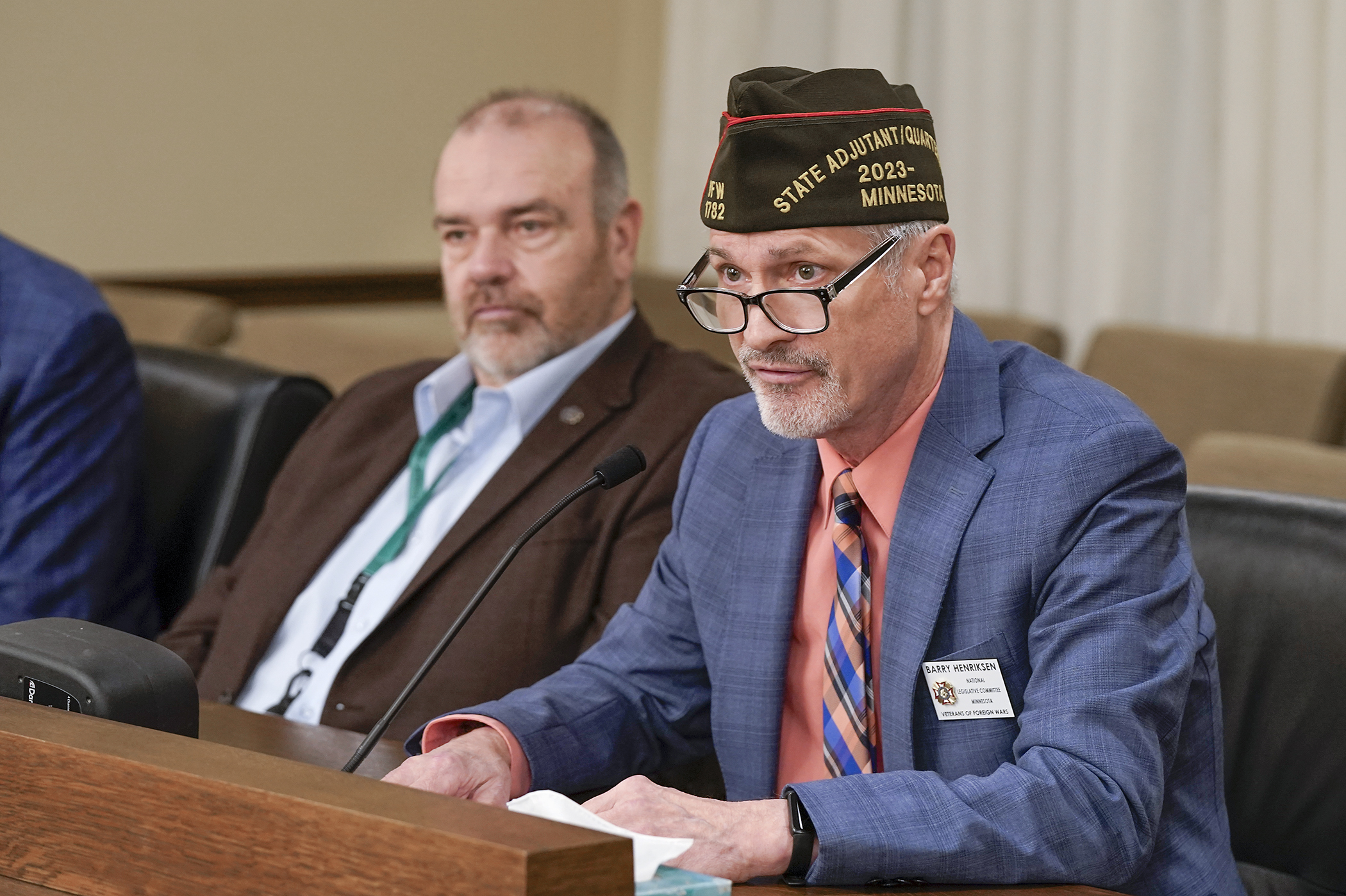 Barry Henriksen, state adjutant/quartermaster and legislative chair at the Department of Minnesota VFW, testifies in support of HF4492 that would codify the Commanders Task Force in statute. Rep. Matt Bliss, left, is the sponsor. (Photo by Michele Jokinen)