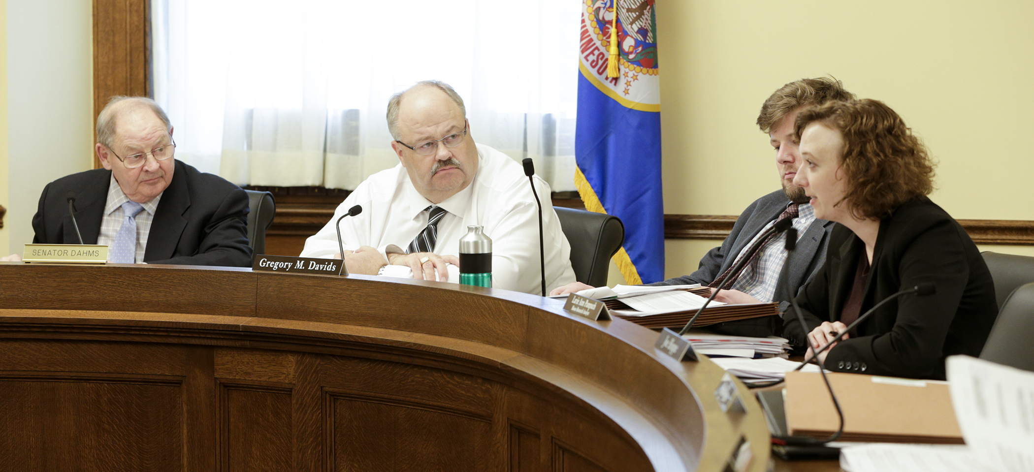Sen. Gary Dahms and Rep. Greg Davids listen as nonpartisan House Research Analyst Larie Pampuch runs through provisions of a delete-all amendment during the March 28 conference committee meeting on HF5. Photo by Paul Battaglia