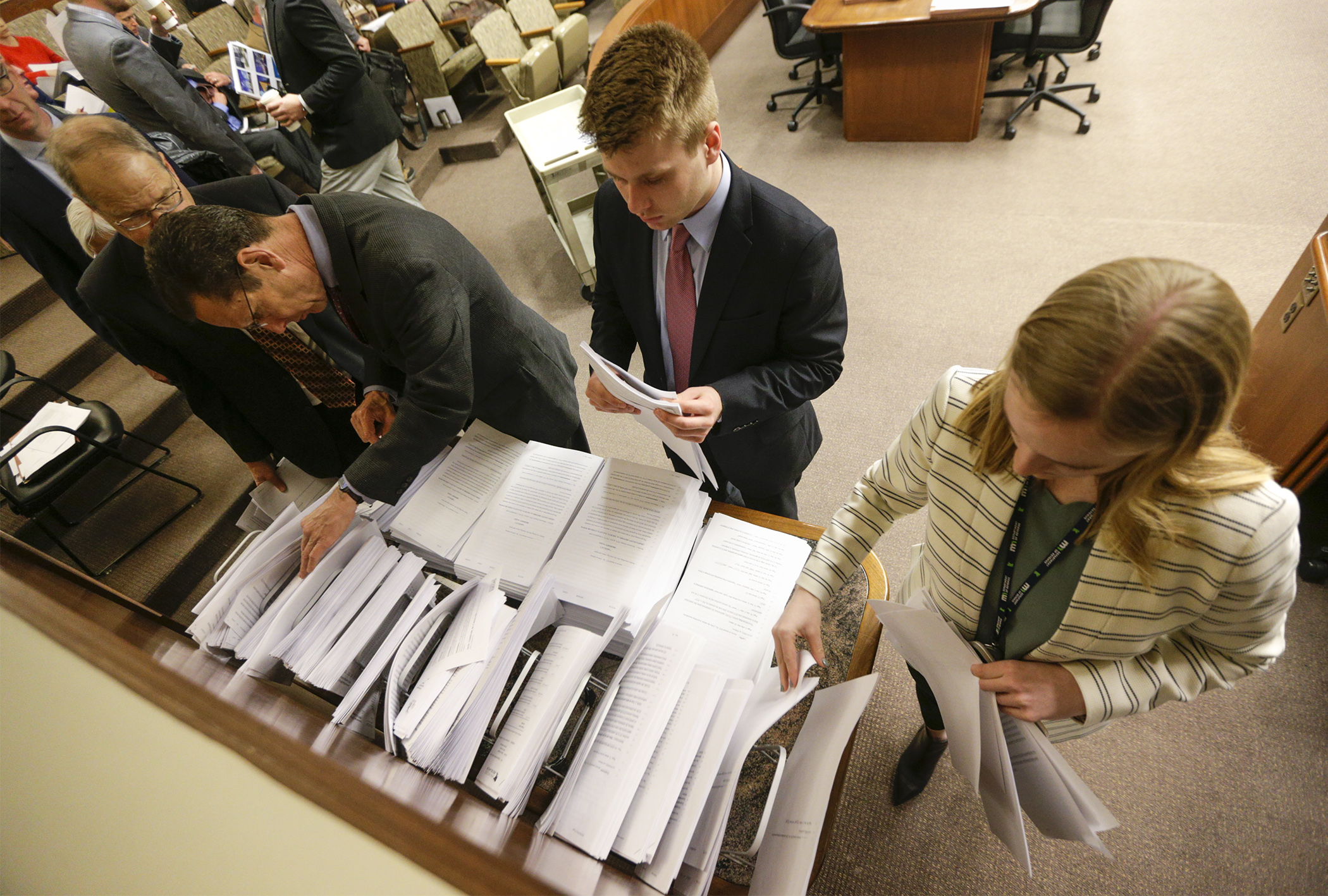 Audience members gather documents as the House Property and Local Tax Division considers amendments to its division report April 1. Photo by Paul Battaglia