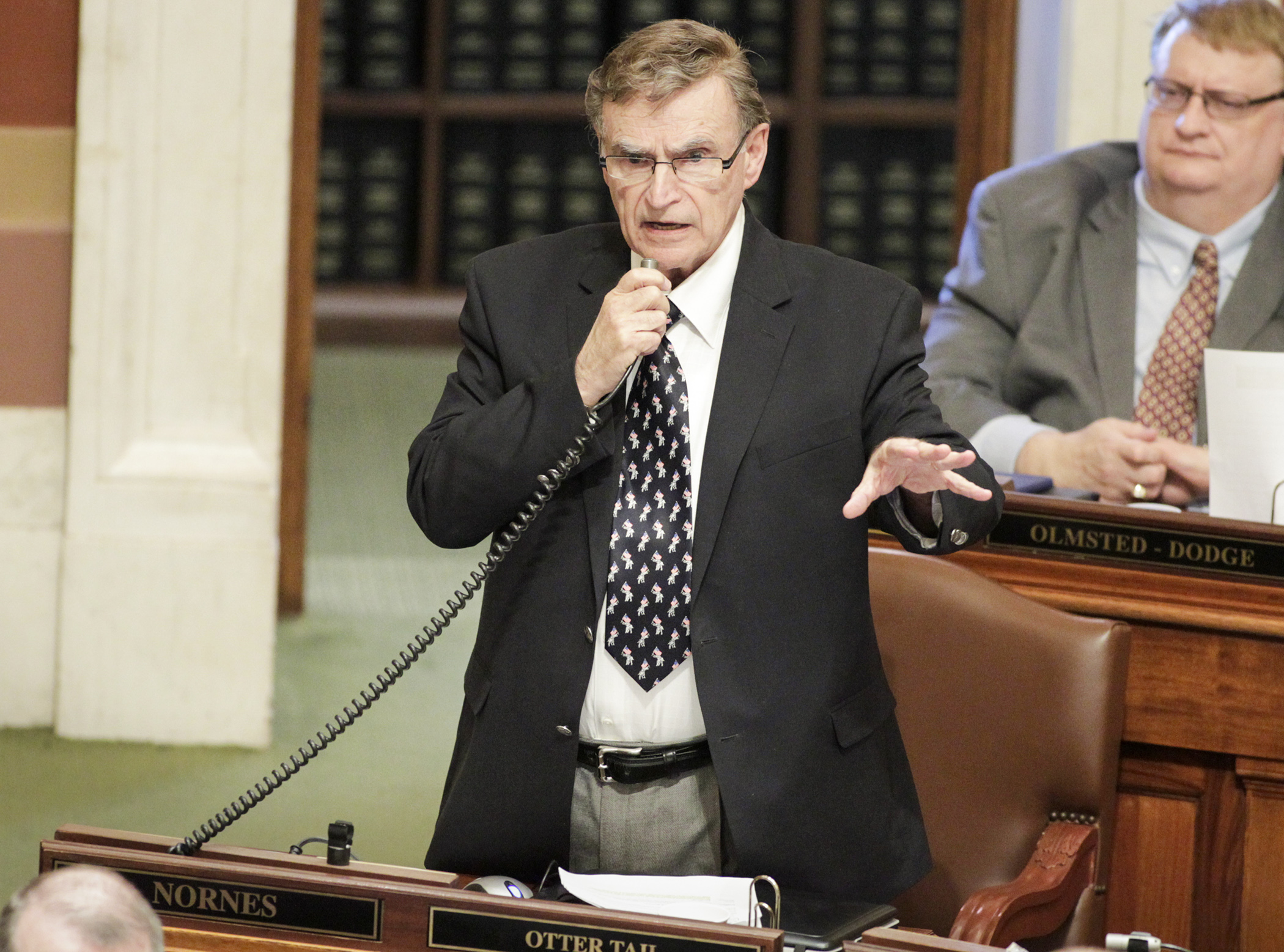 Rep. Bud Nornes, chair of the House Higher Education and Career Readiness Policy and Finance Committee, makes closing comments on the omnibus higher education finance and policy bill during House Floor debate April 4. Photo by Paul Battaglia