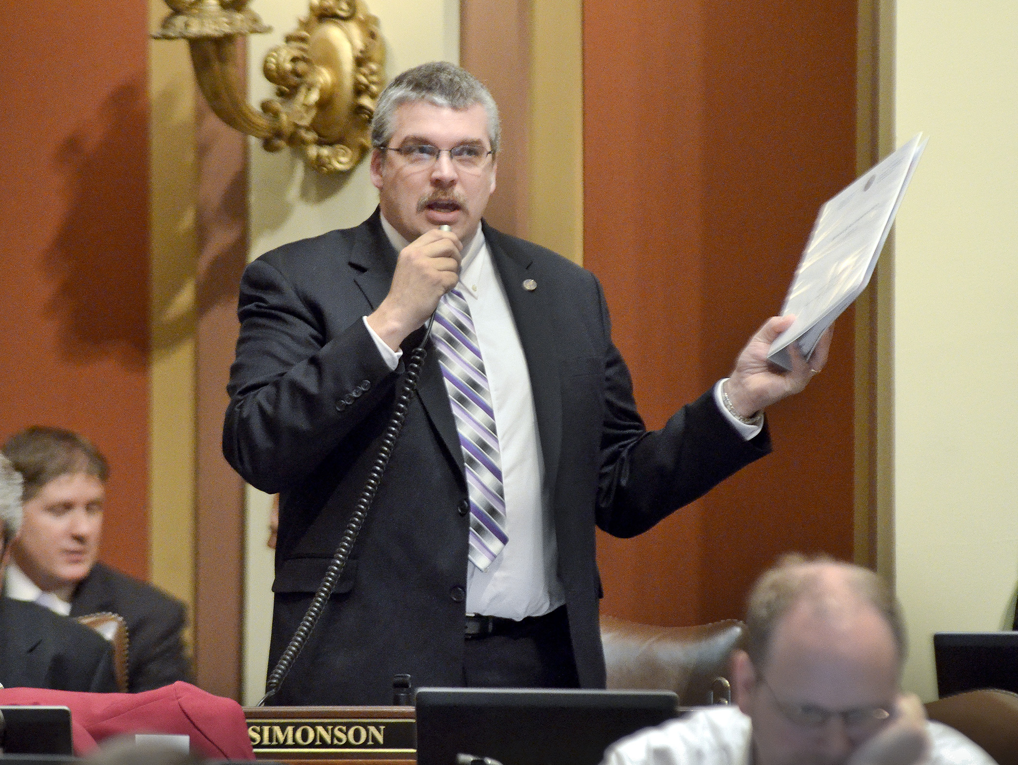 Rep. Erik Simonson presents HF2446 on the House floor April 9. Passed 130-0, the bill now goes to the Senate. Photo by Andrew VonBank
