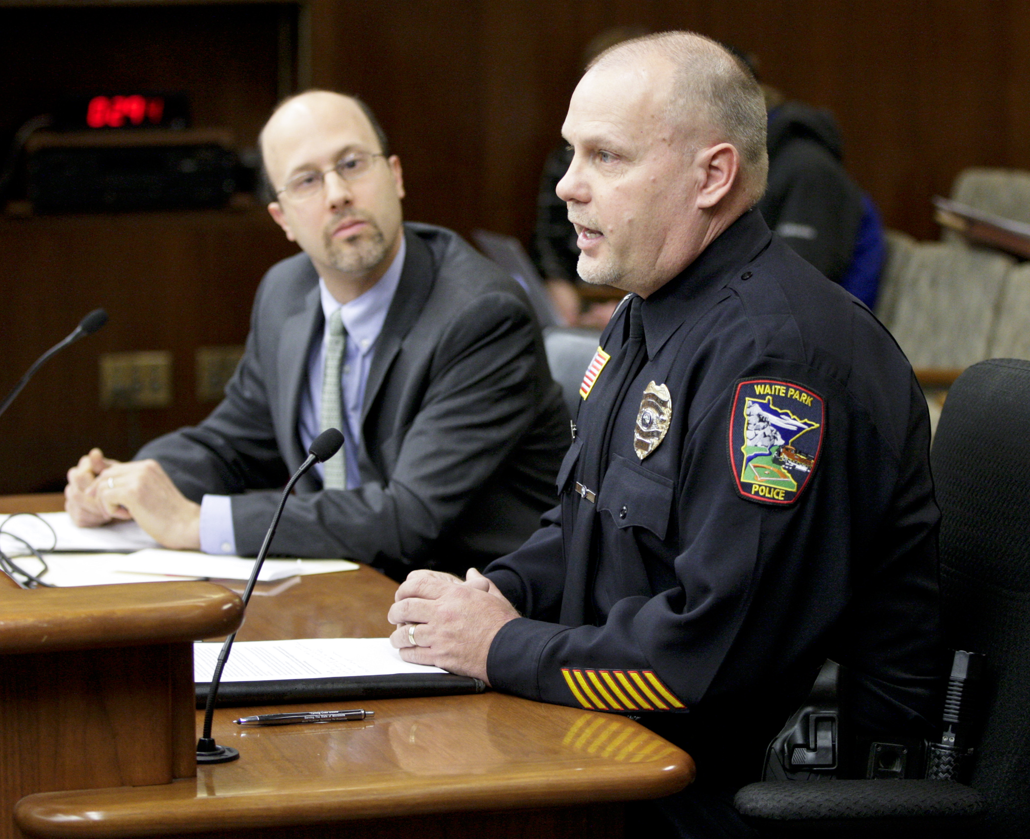 Timothy Deschene, an investigator with the Waite Park Police Department, testifies in favor of HF1776, sponsored by Rep. Dave Pinto, left, which would provide funding to combat sex trafficking crimes. Photo by Paul Battaglia