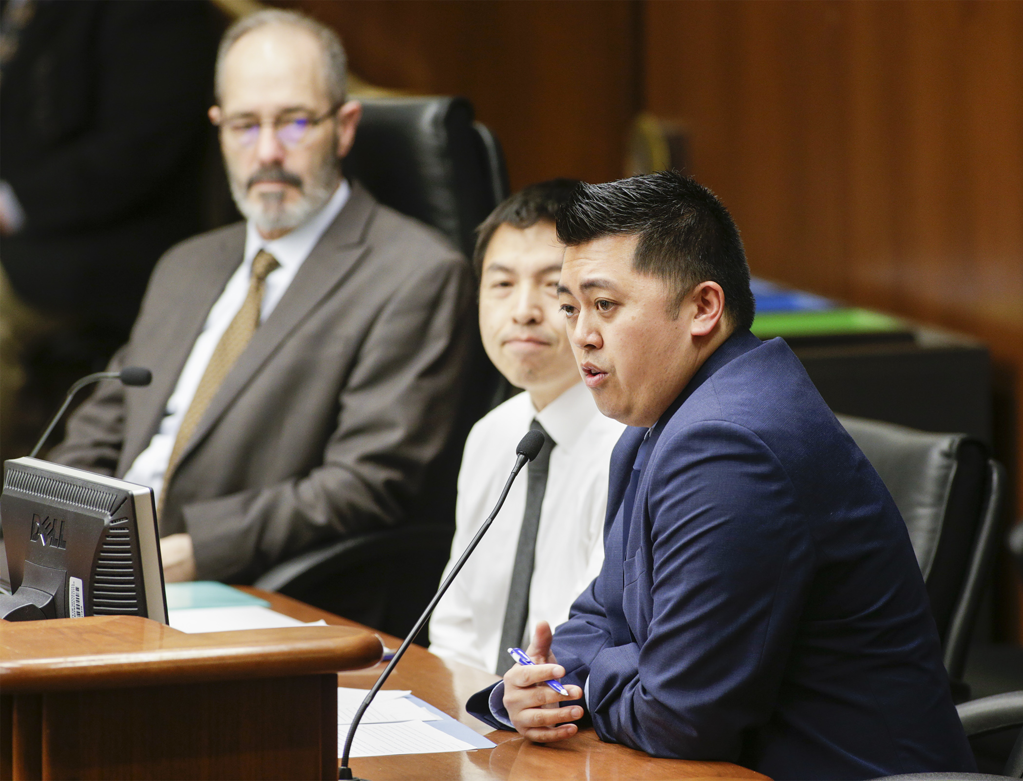 Noah Her testifies before the House Jobs and Economic Development Finance Division on HF2731 sponsored by Rep. Tim Mahoney, left, which would, in part, provide funding to the Hmong Chamber of Commerce. Photo by Paul Battaglia