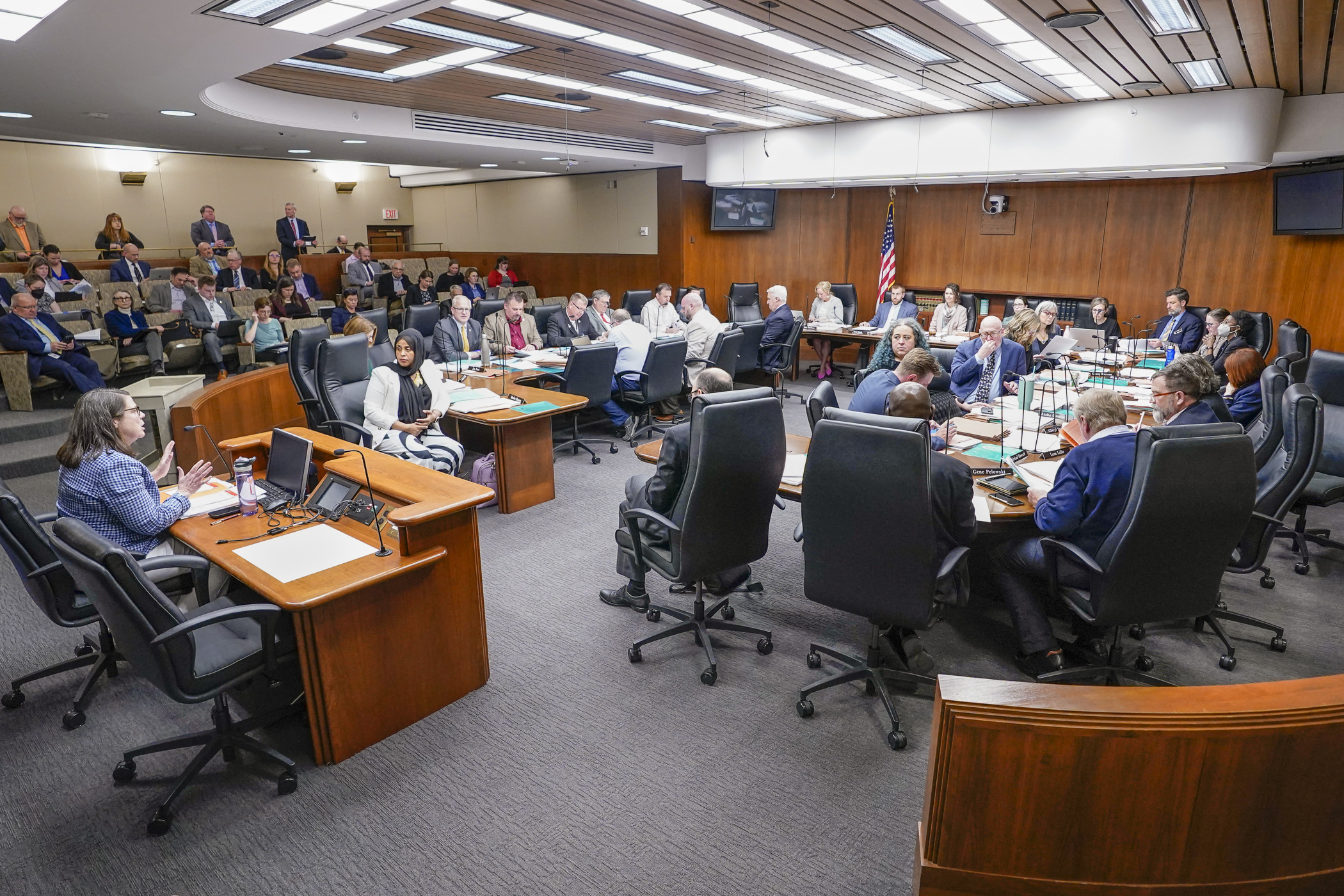 The House Ways and Means Committee discusses the omnibus climate and energy finance bill April 11 before merging it with the omnibus environment and natural resources finance and policy bill. (Photo by Catherine Davis)