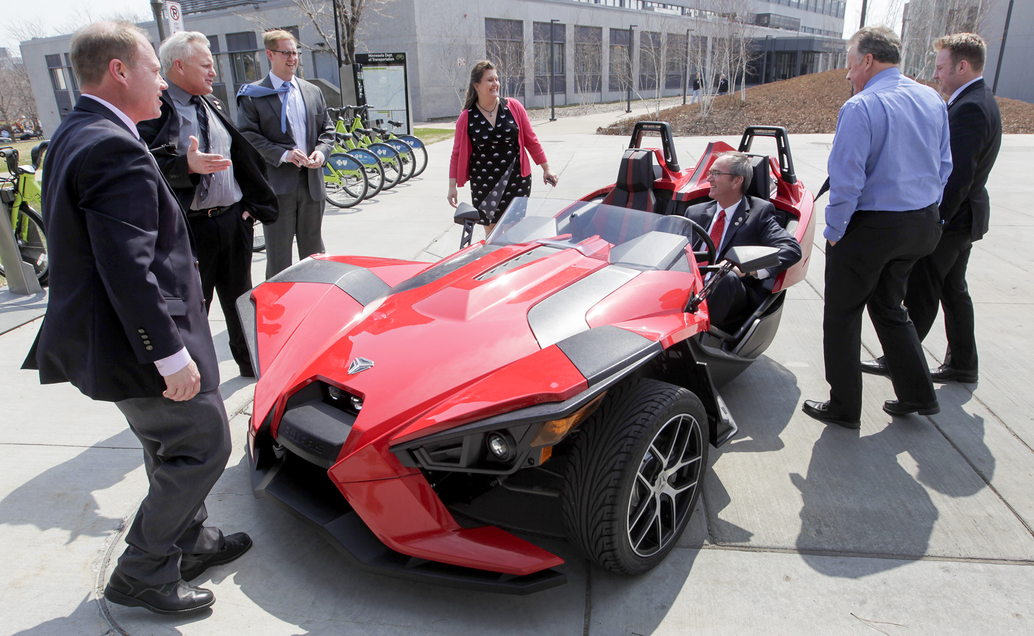 Rep. Dan Fabian sits in a Polaris Slingshot outside the State Office Building April 14 as Rep. Jason Rarick, from left, Rep. Steve Green, House Republican Researcher Harry Merickel, lobbyist Lynda Lisenby, Rep. Chad Anderson and Rep. Mark Uglem look on. Fabian sponsors HF3014 that would allow an “autocycle” to be operated without a motorcycle endorsement. Photo by Paul Battaglia