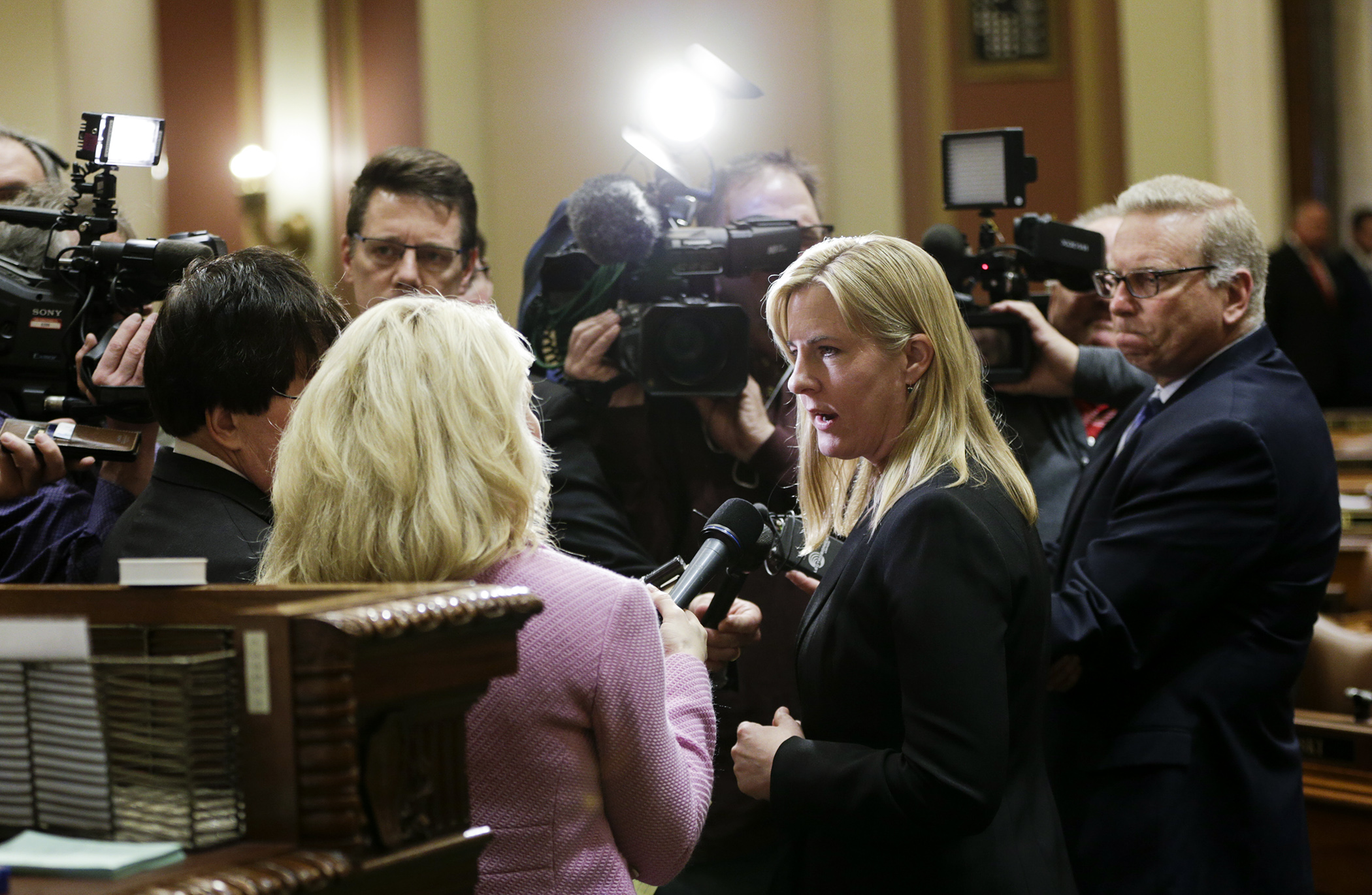 House Minority Leader Melissa Hortman, center, meets with members of the media on the House Floor April 18. Photo by Paul Battaglia