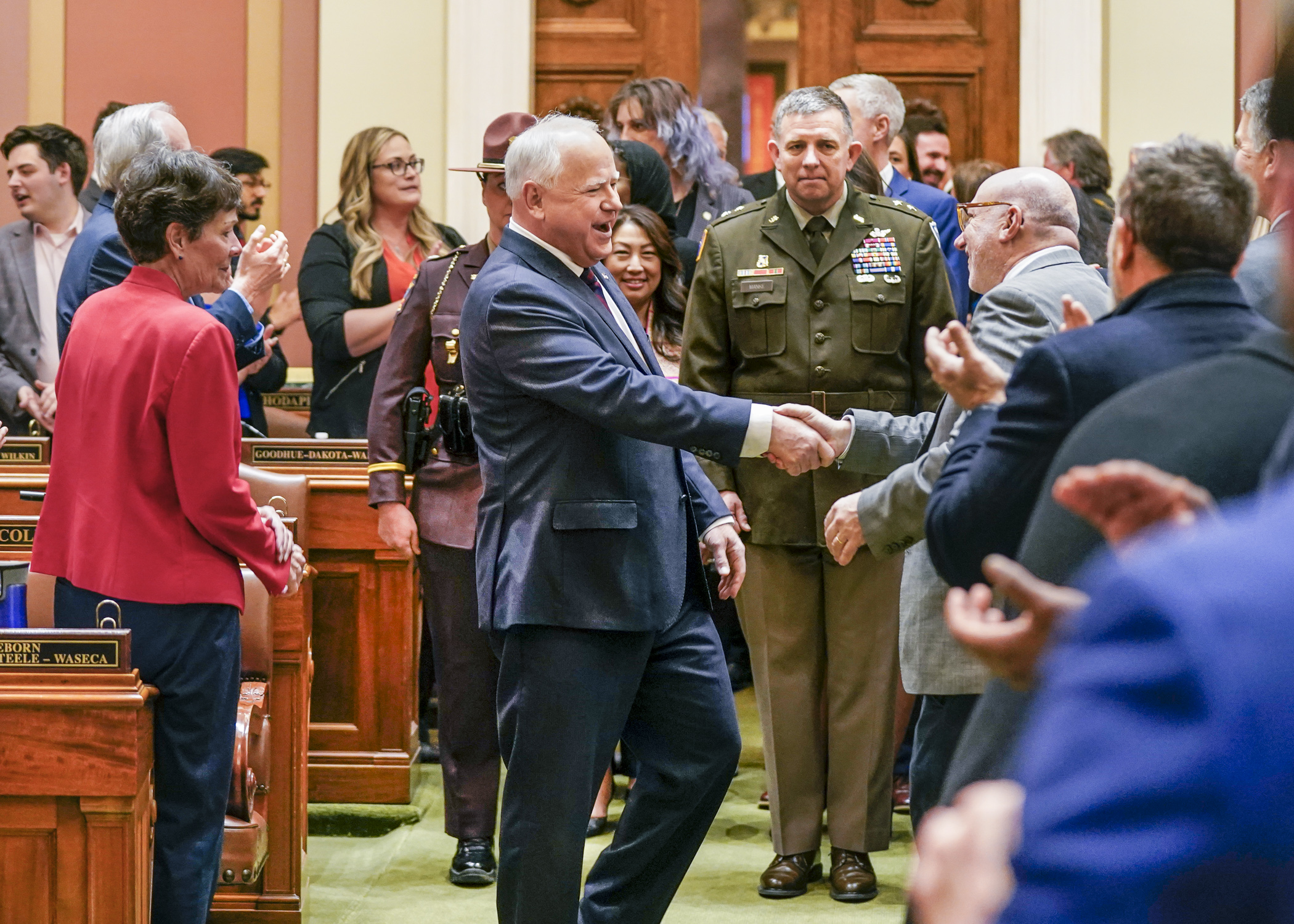 Gov. Tim Walz shakes the hand of Rep. Frank Hornstein as he makes his way into the House Chamber to deliver the State of the State address April 19. (Photo by Catherine Davis)