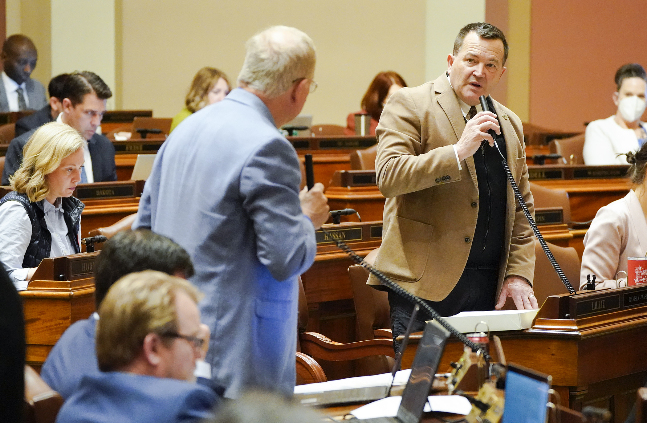 Rep. Leon Lillie, chair of the House Legacy Finance Committee, answers a question from Rep. Dean Urdahl during debate on the omnibus Legacy finance bill April 25. The bill passed on a 70-62 vote. (Photo by Paul Battaglia)